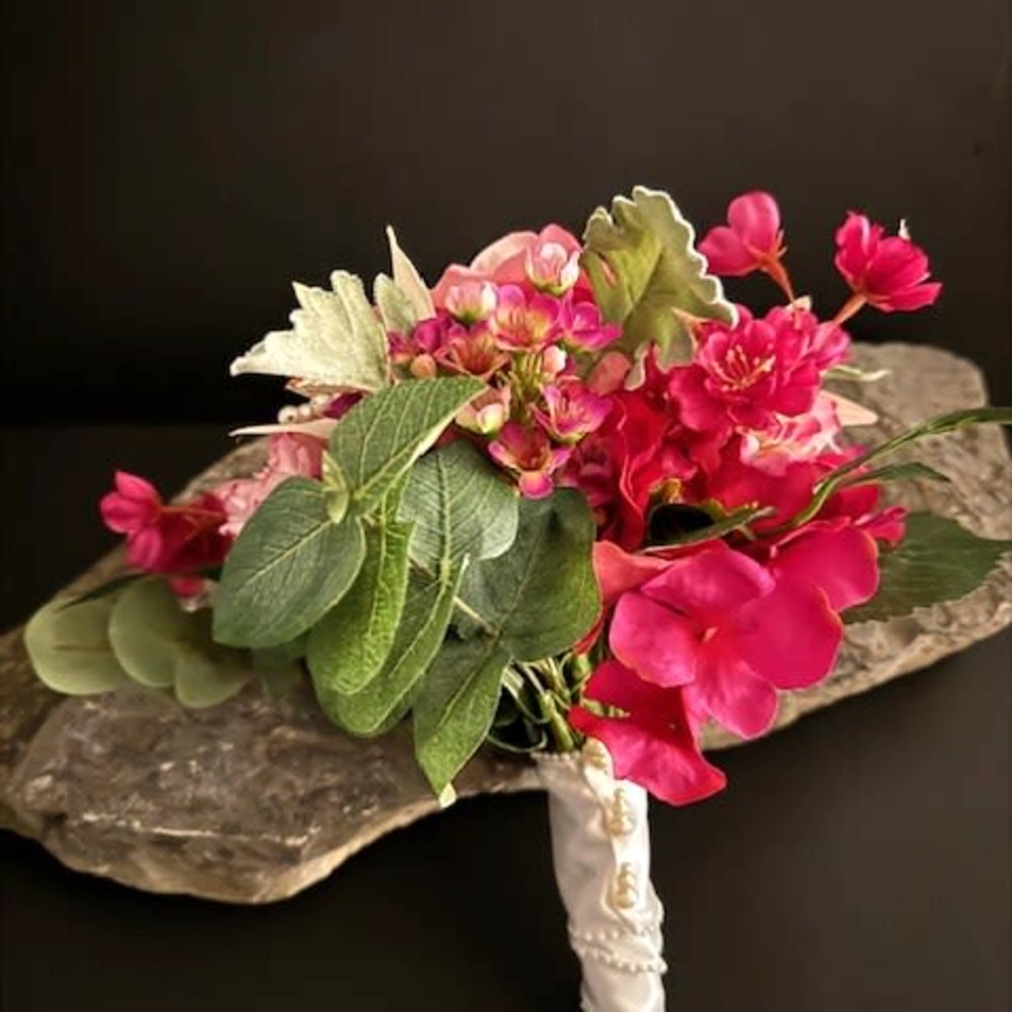 A lush, hand-held fuchsia hydrangea-style bouquet centered on a single large pink, photo 2 of 3
