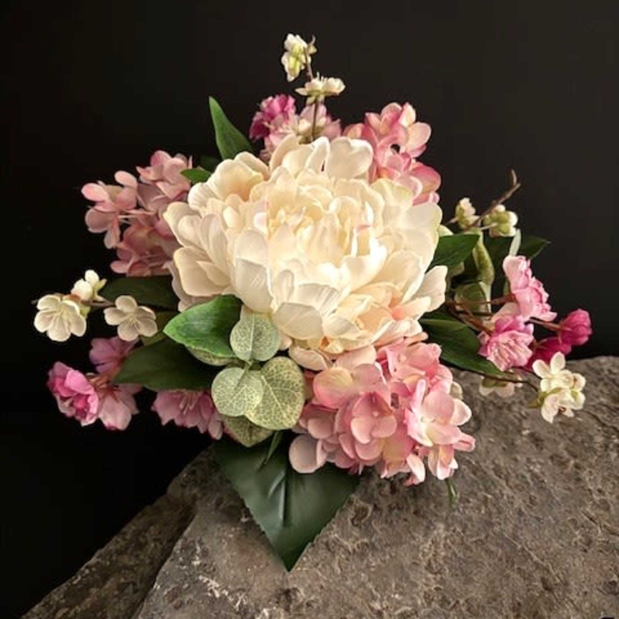 A large ivory peony-style bloom anchors this silk wedding bouquet, its smooth