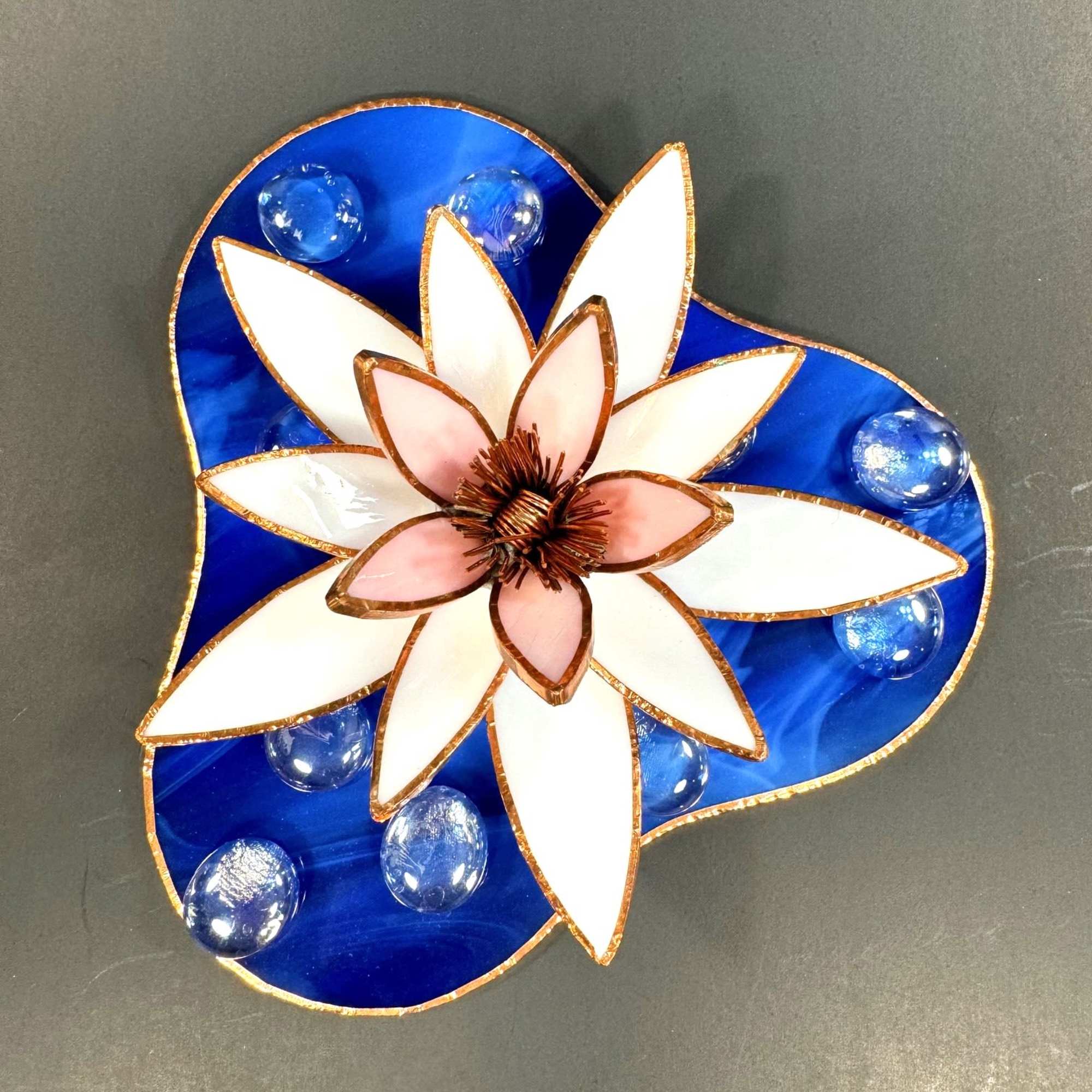 A layered stained-glass waterlily in soft white petals with a blush-pink core, photo 2 of 2