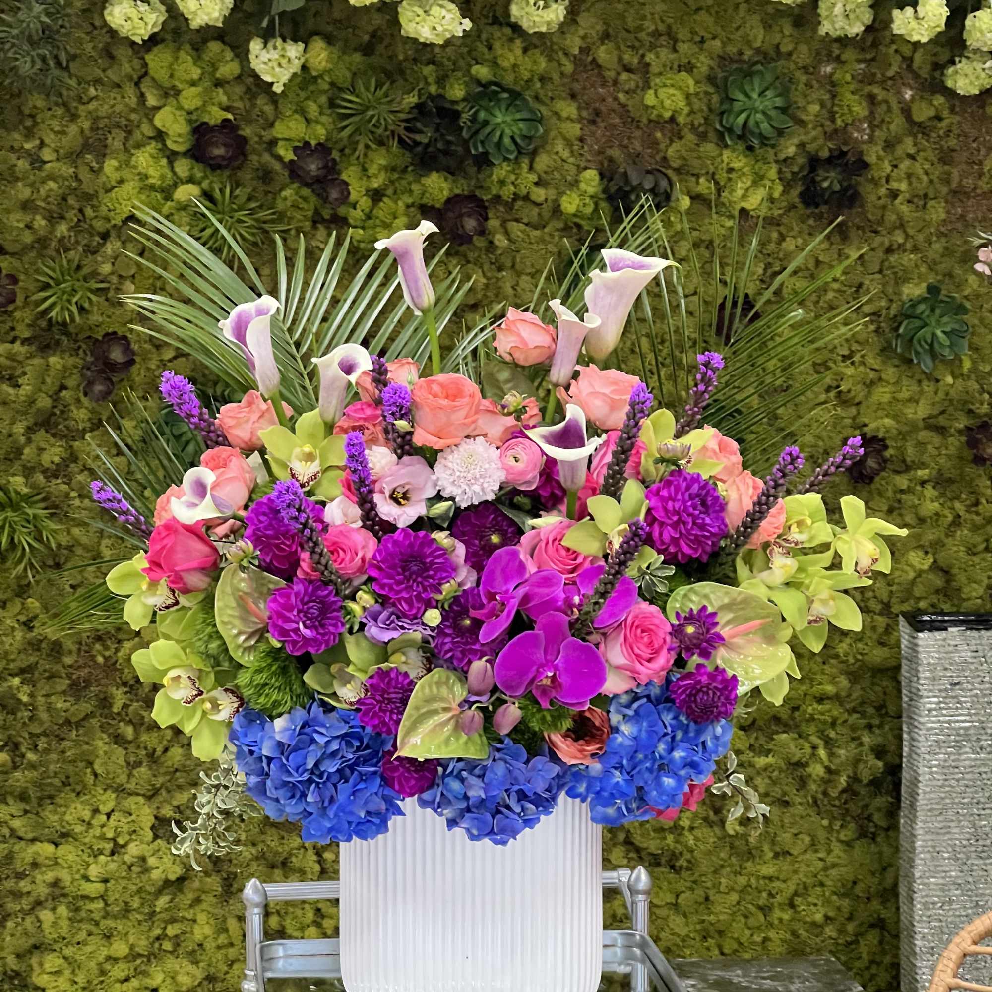 Colorful mixed flower arrangement in a white vase