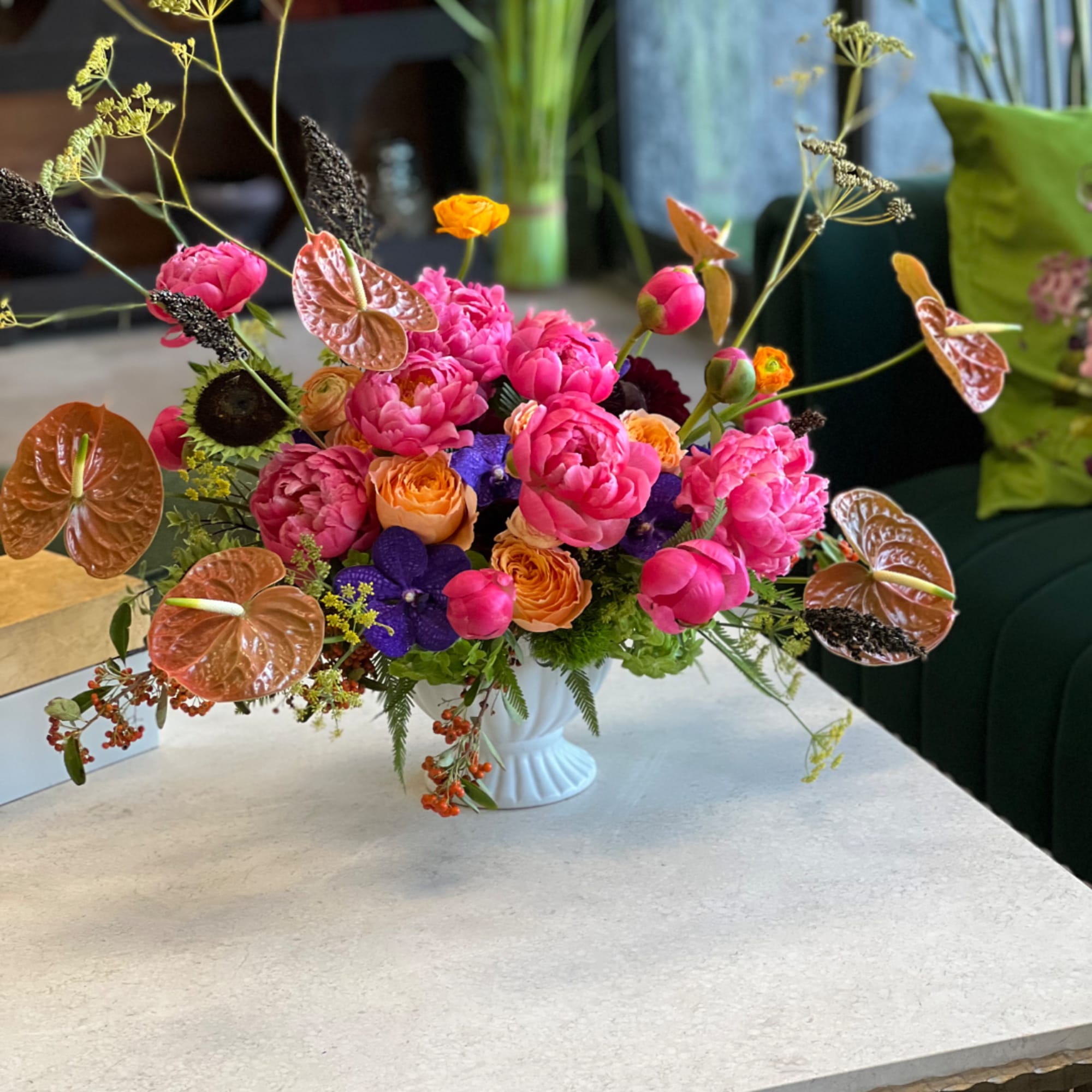 Bright mixed bouquet in a white vase with pink and orange blooms