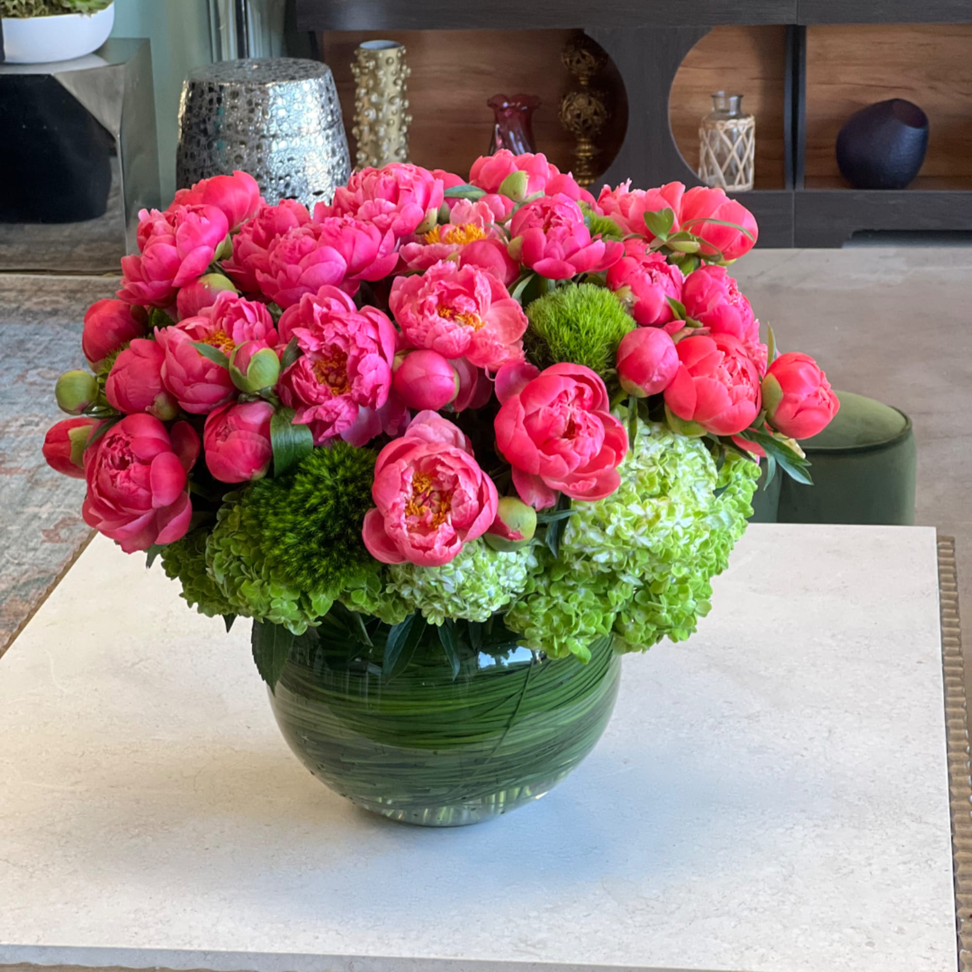 Pink peonies and green hydrangeas in a round glass vase, photo 2 of 2