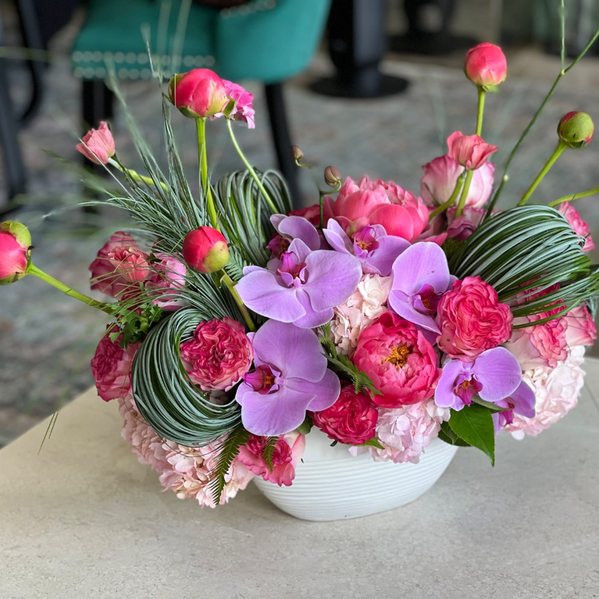 Pink and lavender floral arrangement in a white bowl vase, photo 3 of 3
