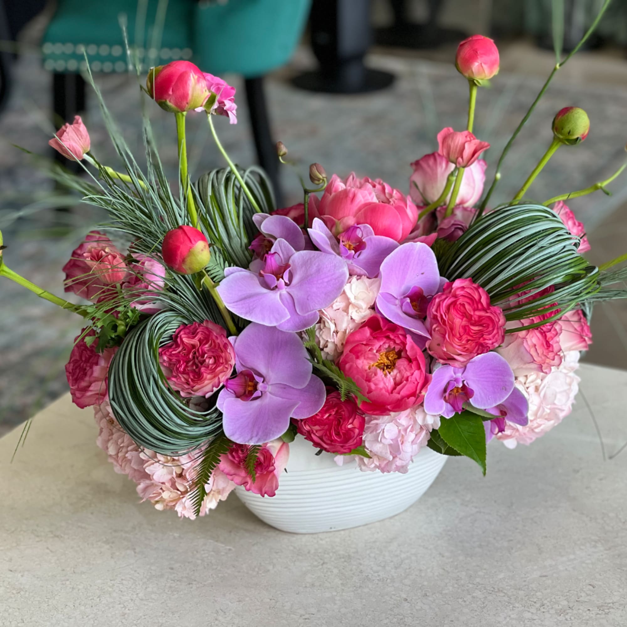 Pink and lavender floral arrangement in a white bowl vase, photo 2 of 3