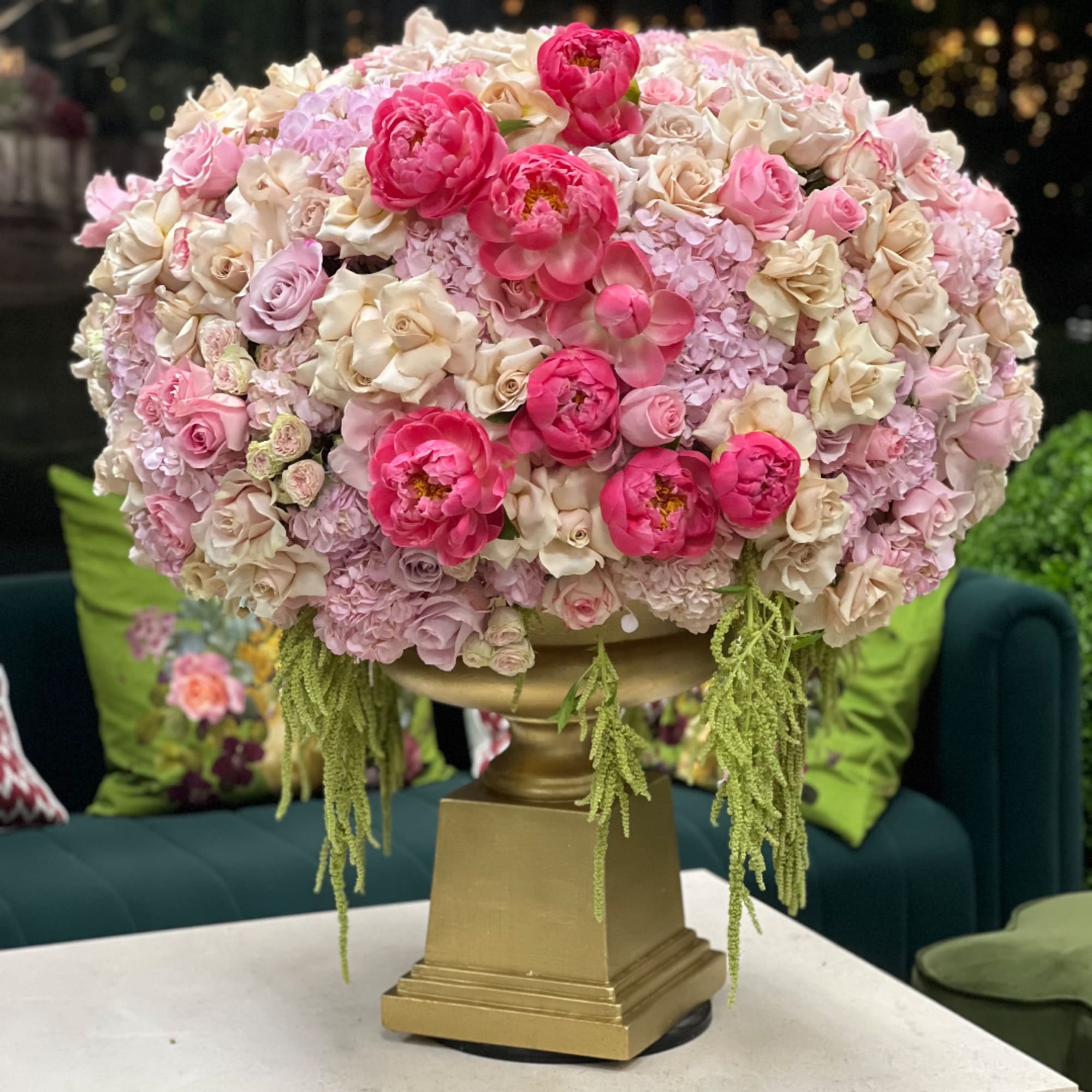 Large pink and cream floral arrangement in a gold pedestal vase, photo 2 of 2