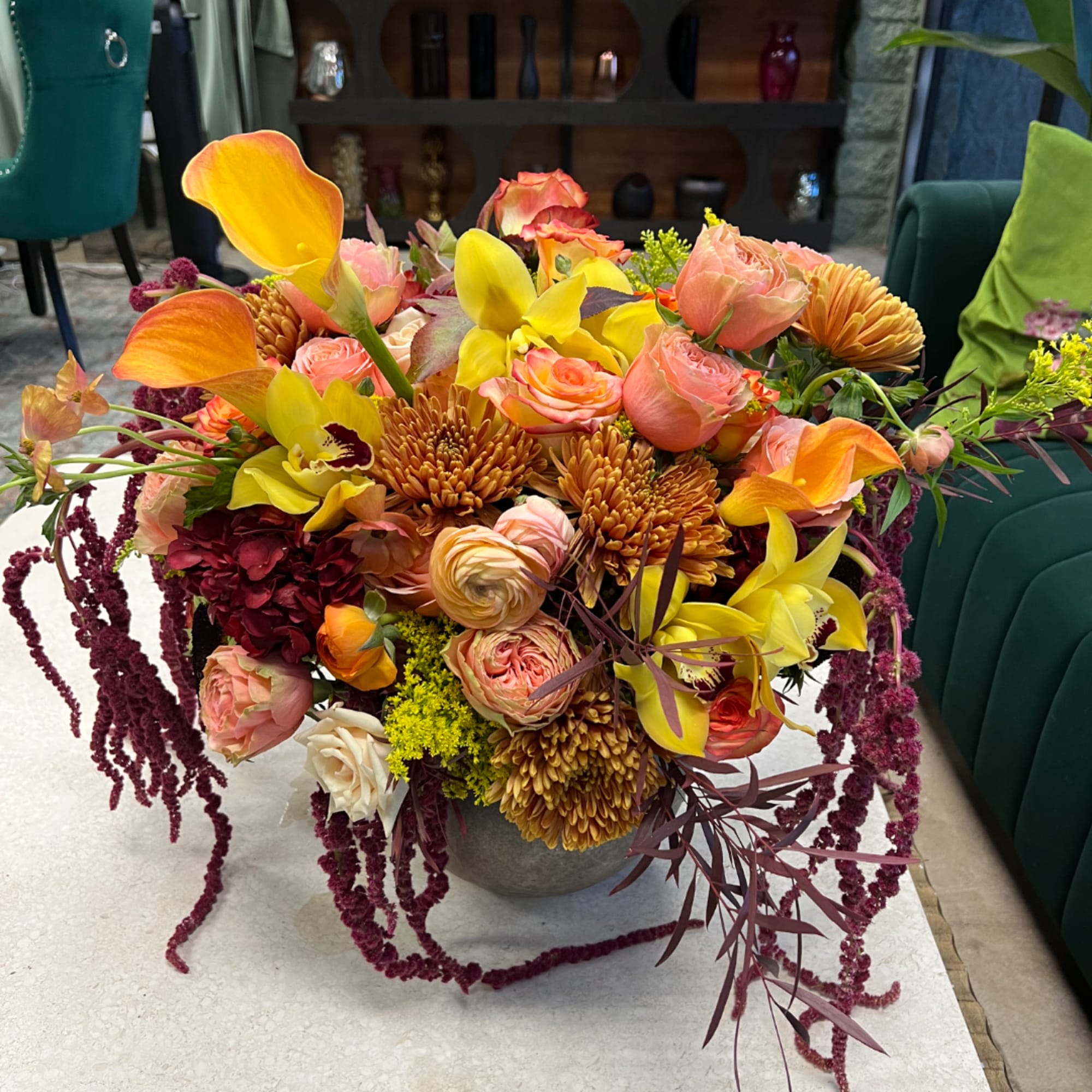 Colorful mixed flower arrangement in a low gray vase
