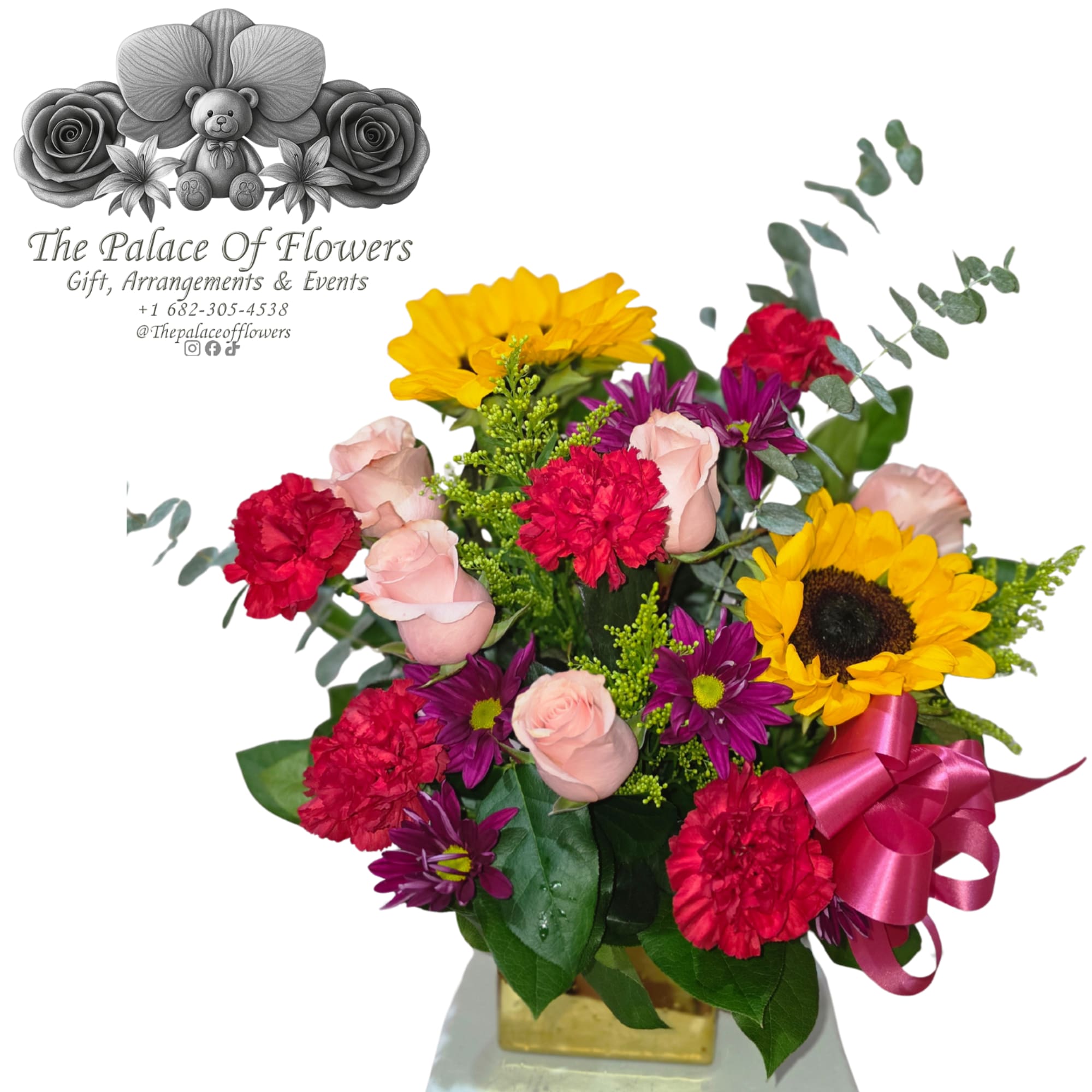 Mixed bouquet with sunflowers, roses, carnations, and purple daisies in a vase