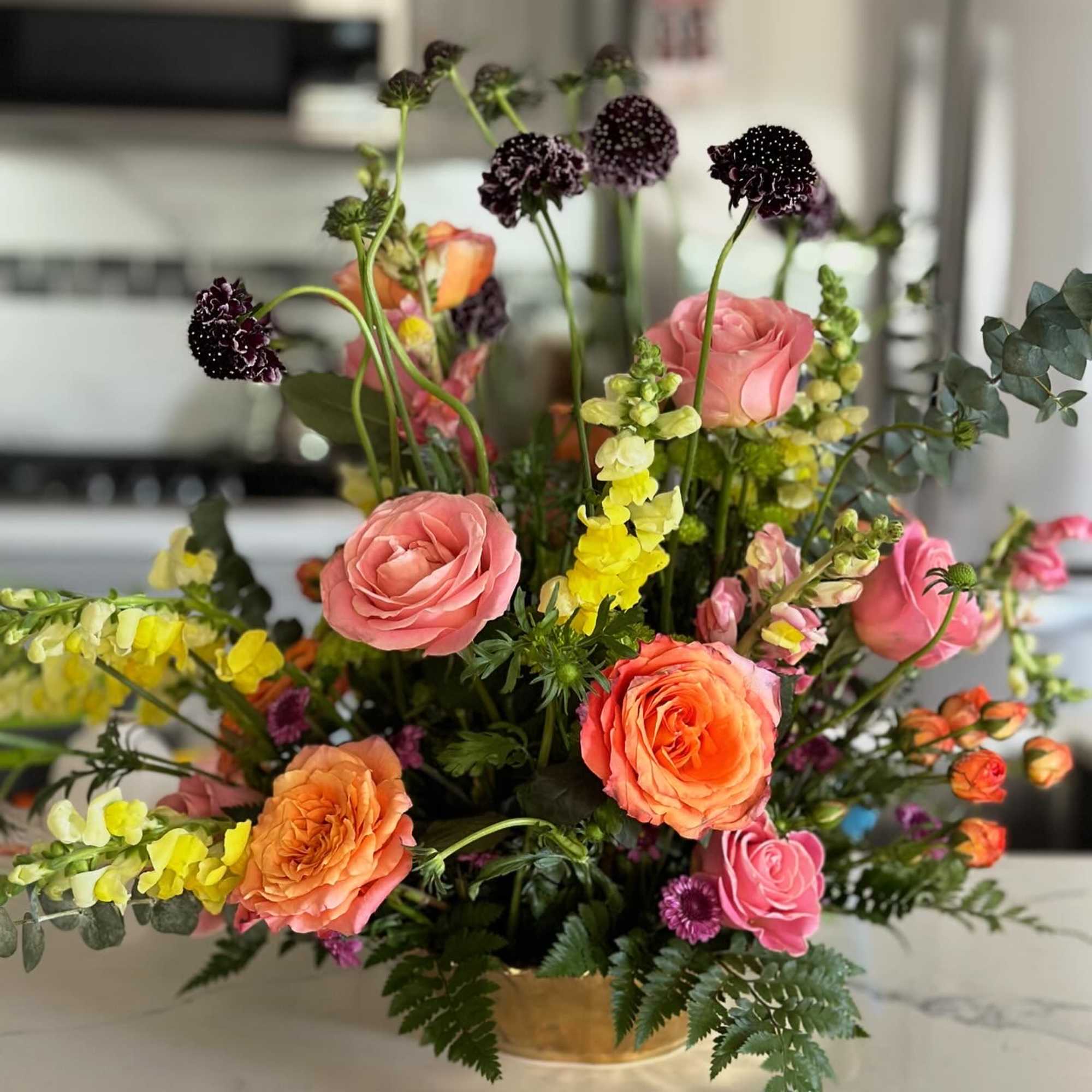 A floral arrangement full of life, color, and natural movement, inspired by