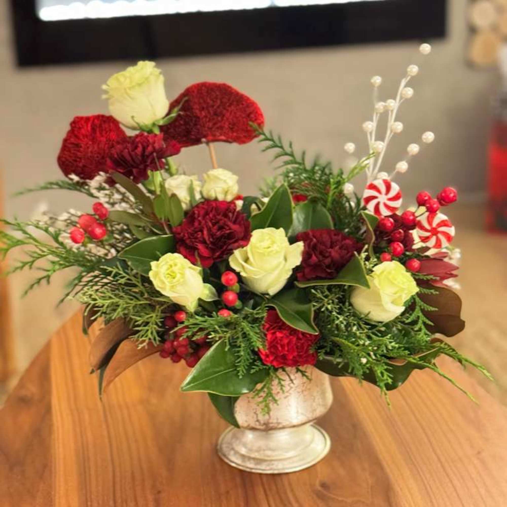 Our Holiday Elegance Floral Arrangement is a refined seasonal design created with