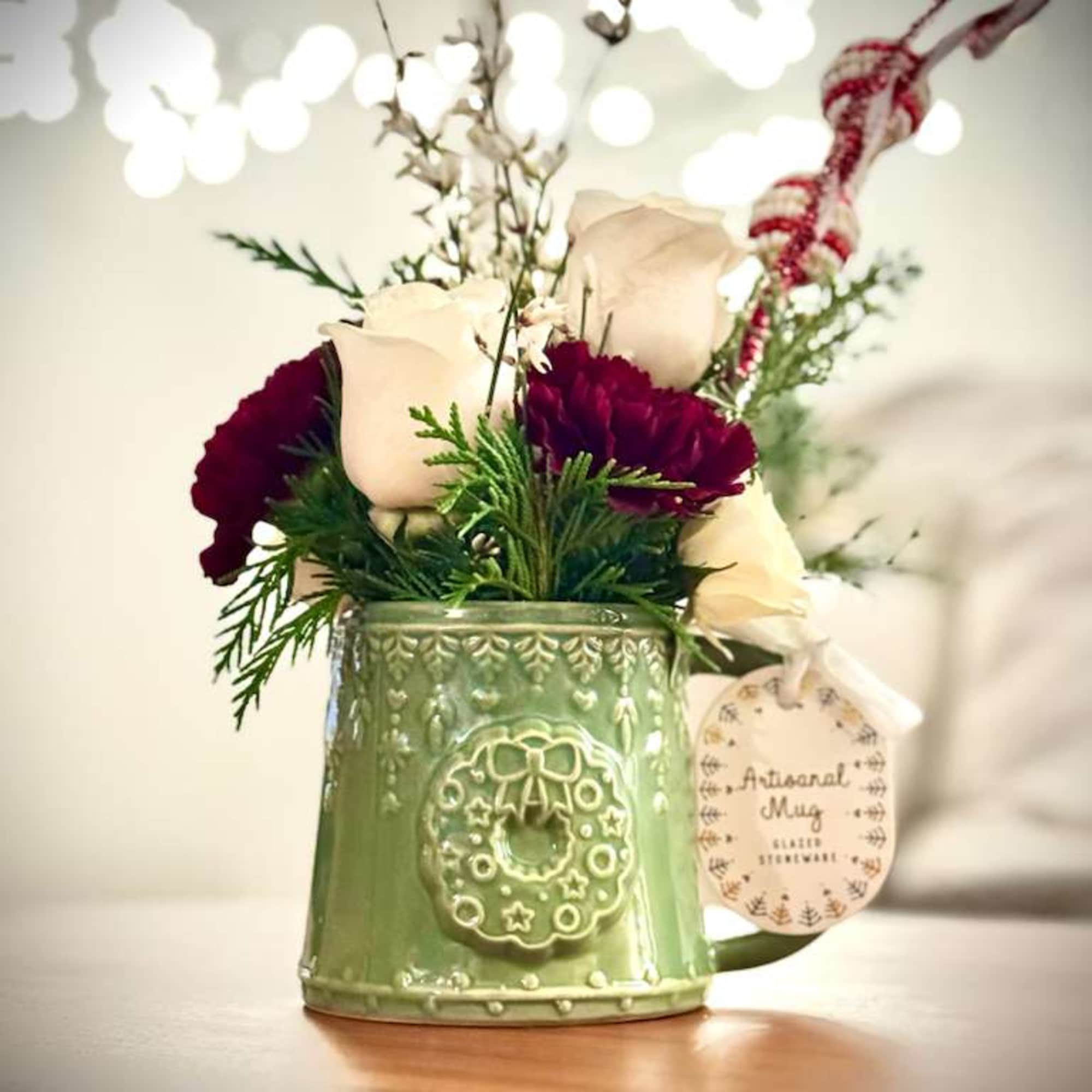 Our Christmas Mug Floral Arrangement is a charming seasonal design created in, photo 2 of 3