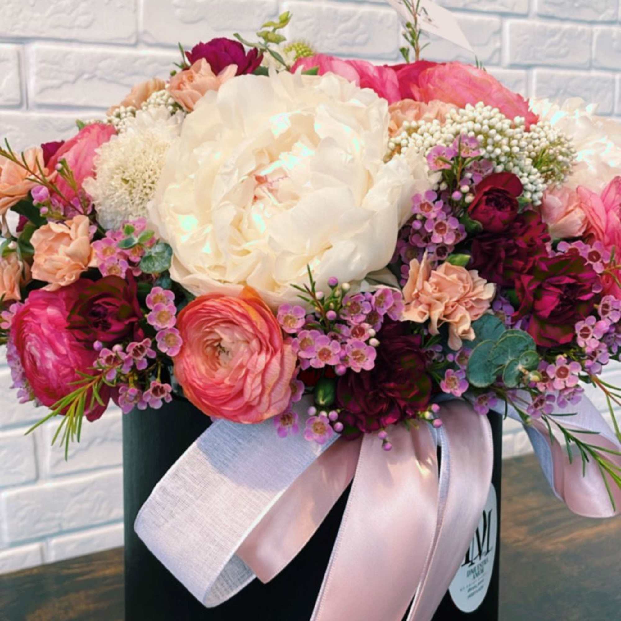 This exquisite floral arrangement is designed in a matte black flower box