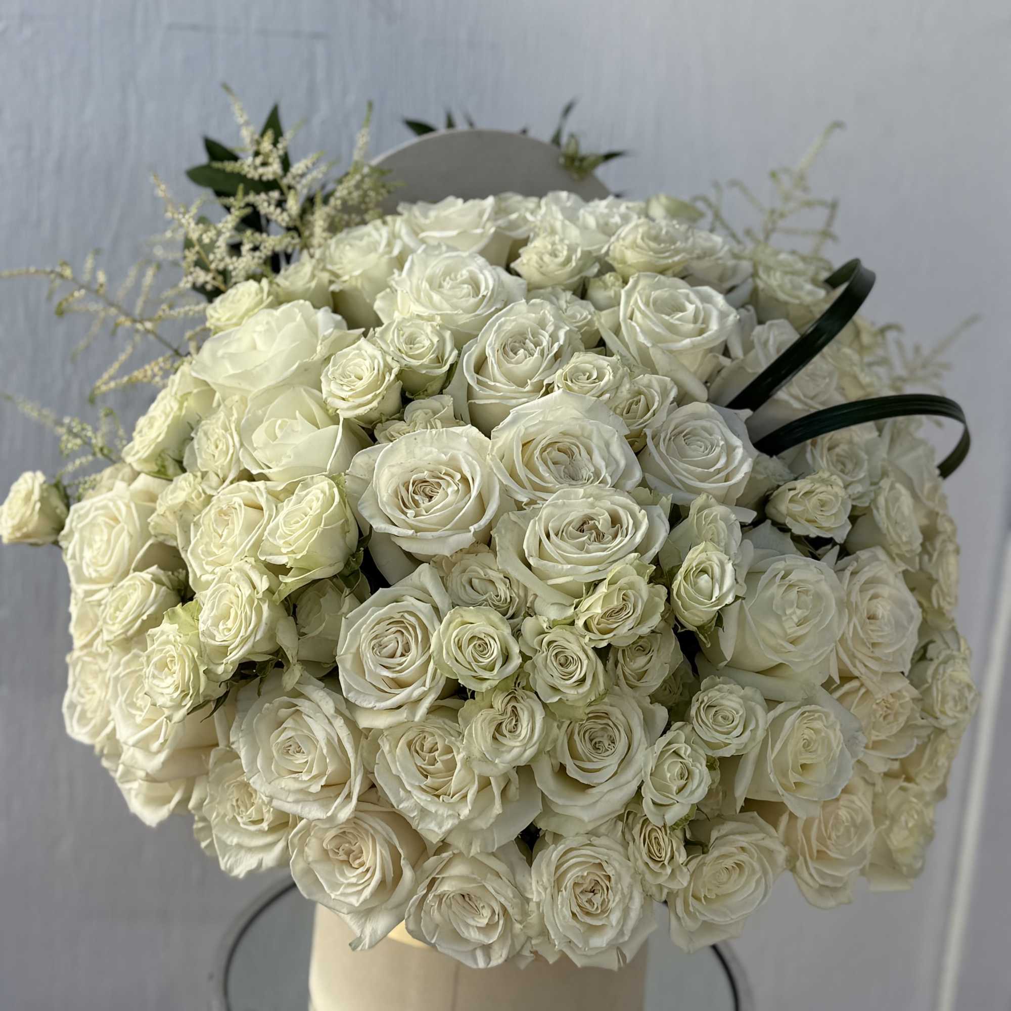 A luxurious arrangement featuring 50 premium white roses paired with delicate white, photo 2 of 2