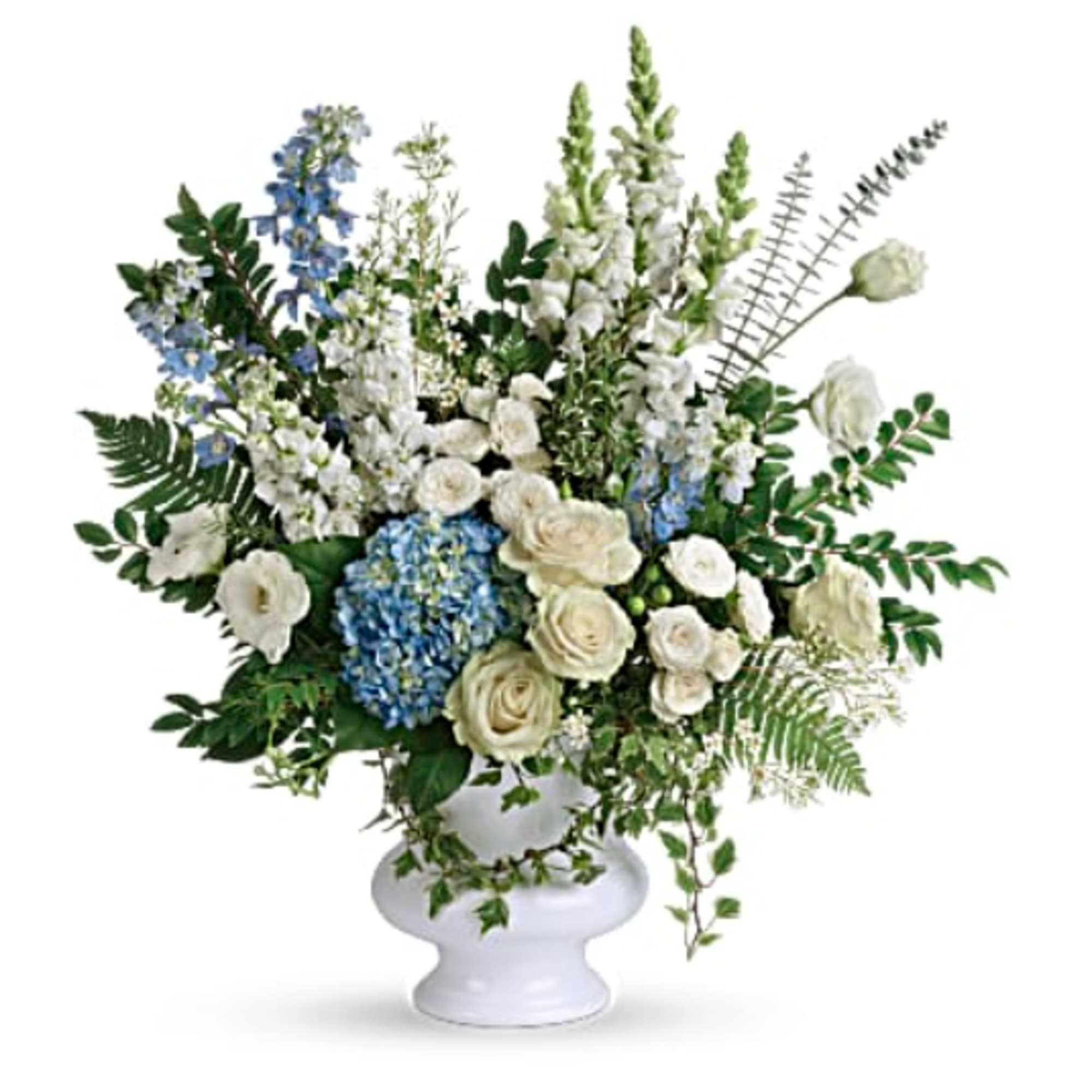 White and blue floral arrangement in a white pedestal vase