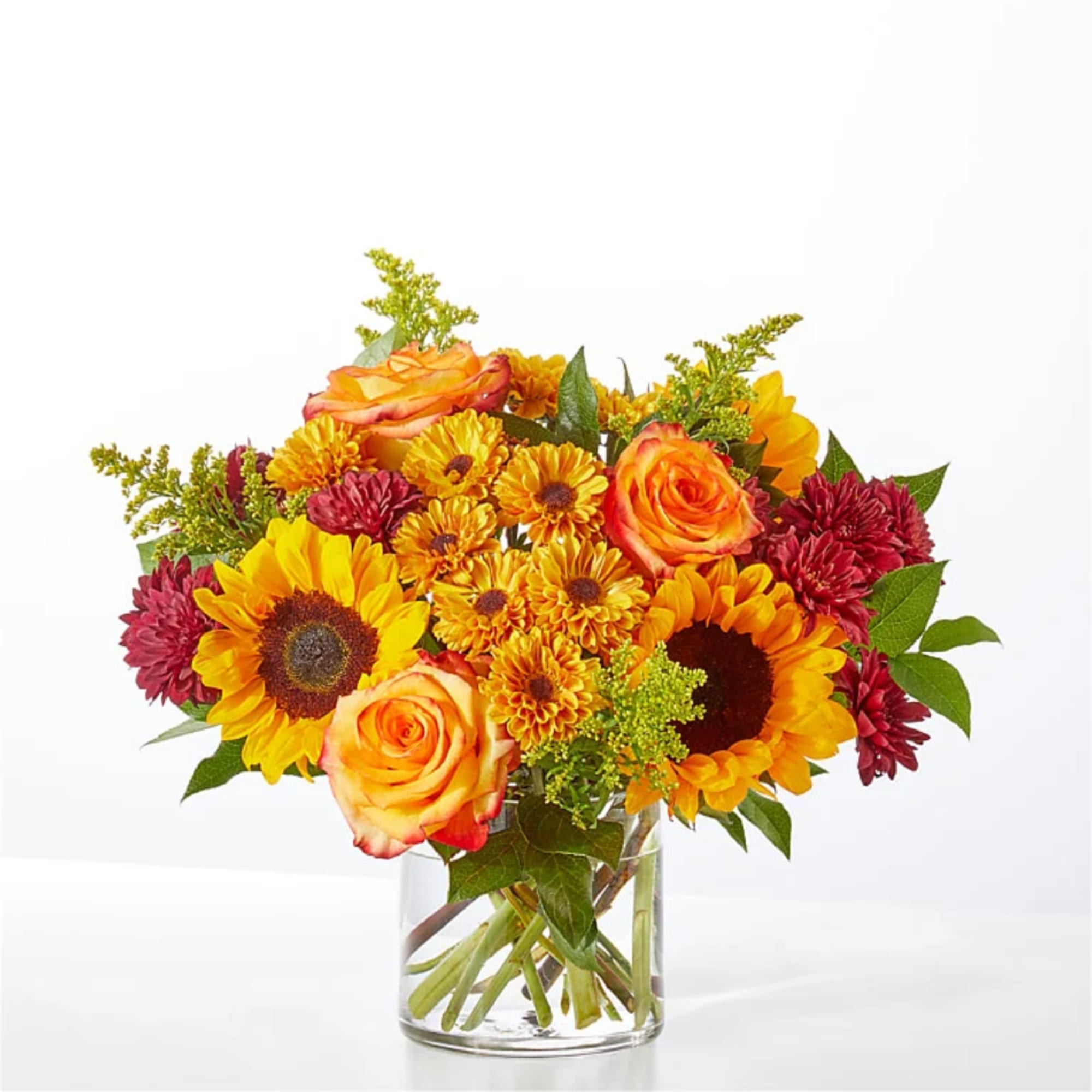 Sunflower, rose, and chrysanthemum bouquet in a clear glass vase