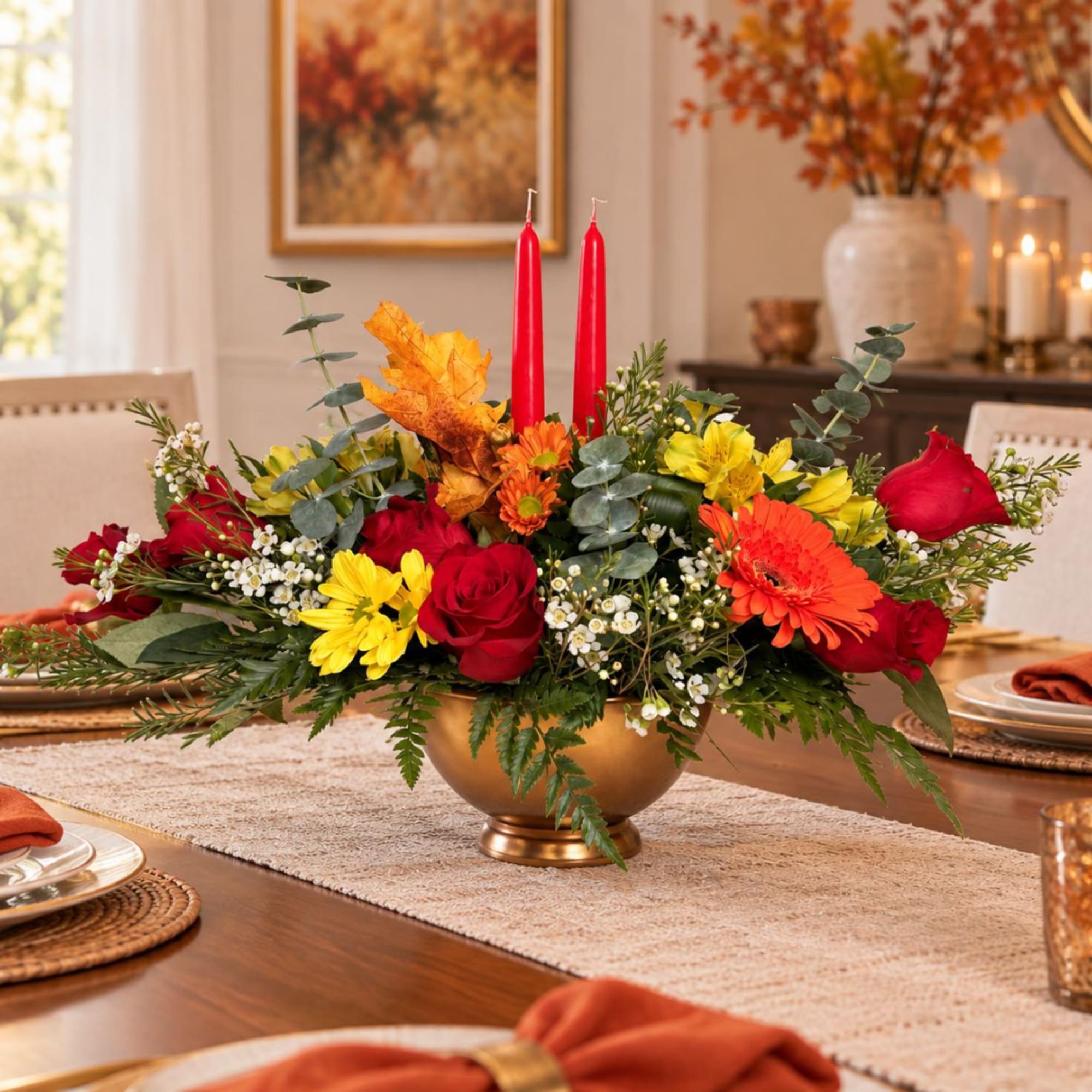 Autumn floral centerpiece with red candles in a gold bowl