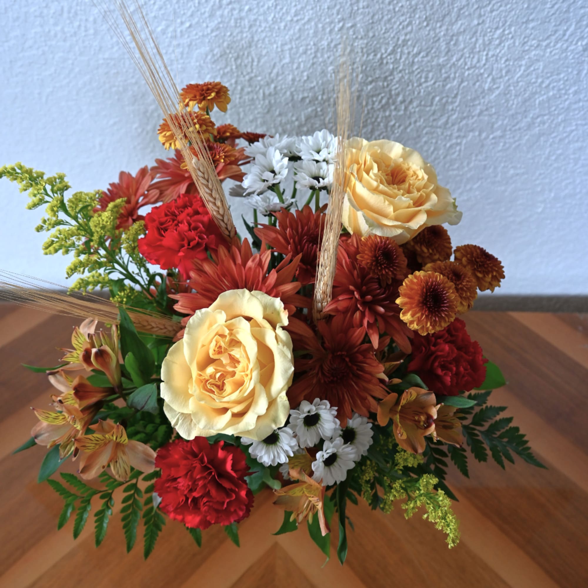 Mixed bouquet with yellow roses, red carnations, and orange chrysanthemums
