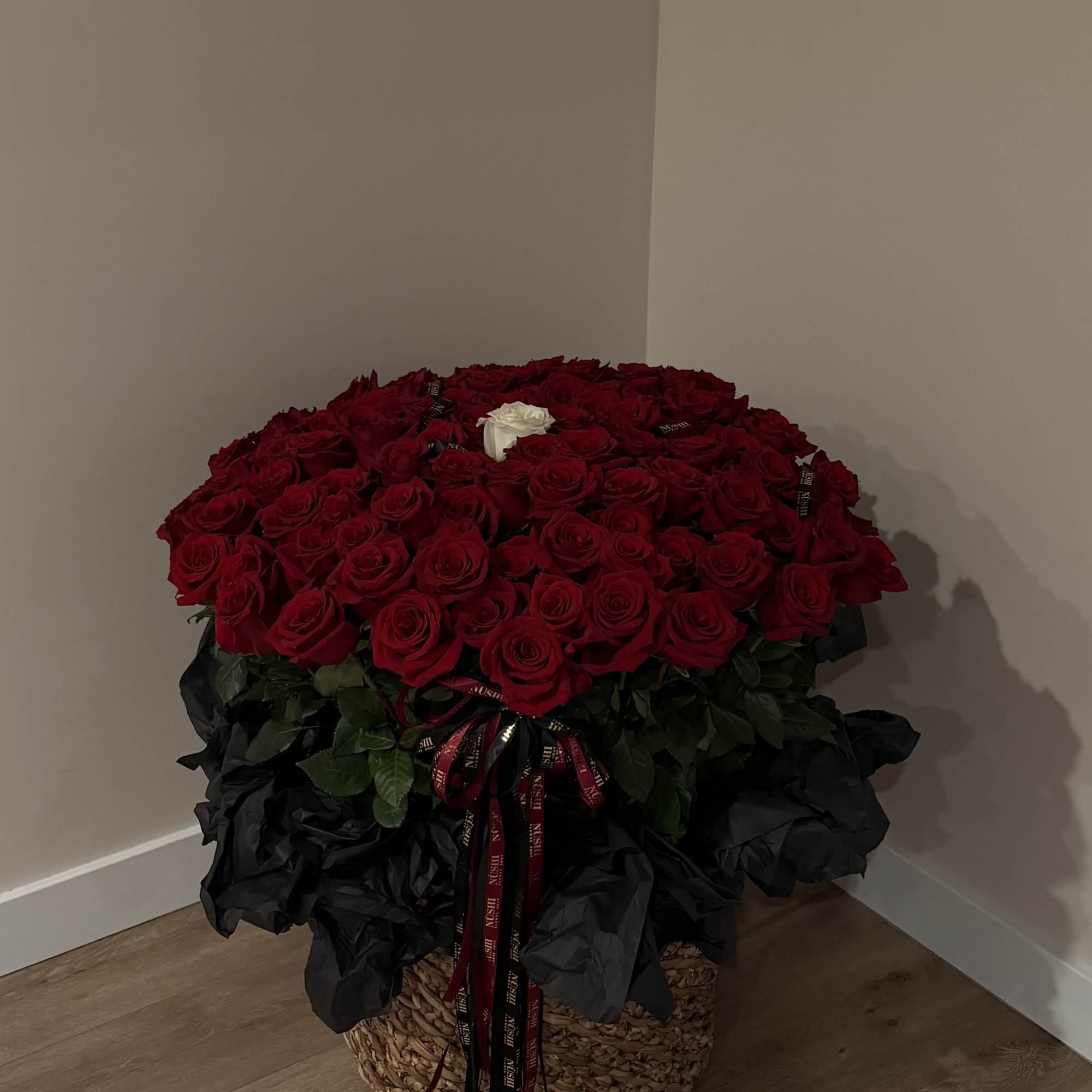 A luxurious XL basket featuring 101 premium red roses, beautifully arranged to