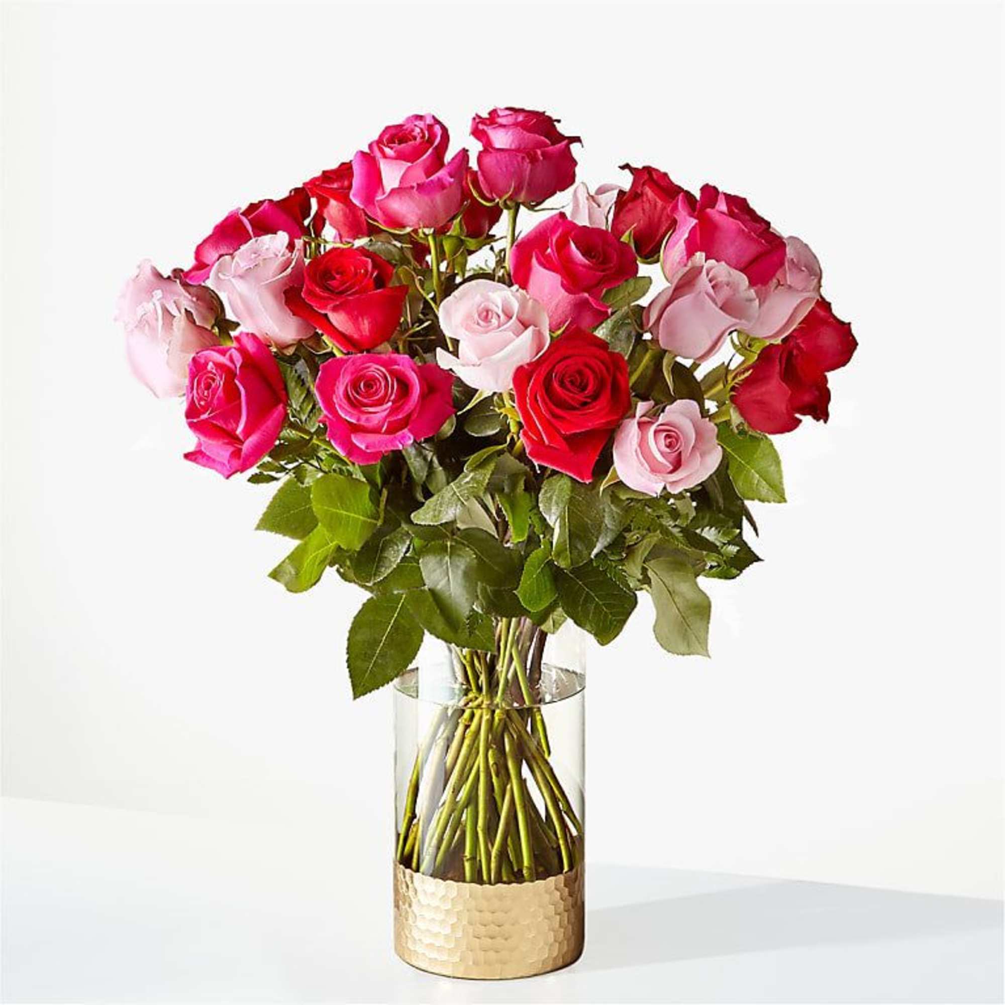 Bouquet of pink and red roses in a clear glass vase