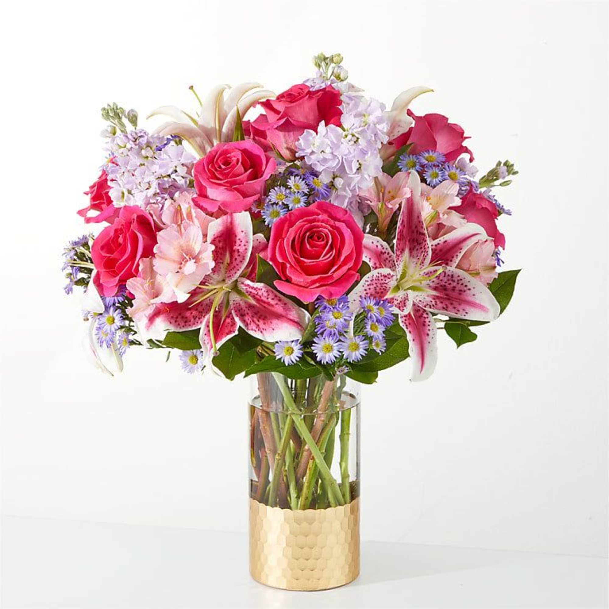 Bouquet of pink roses and lilies in a clear glass vase