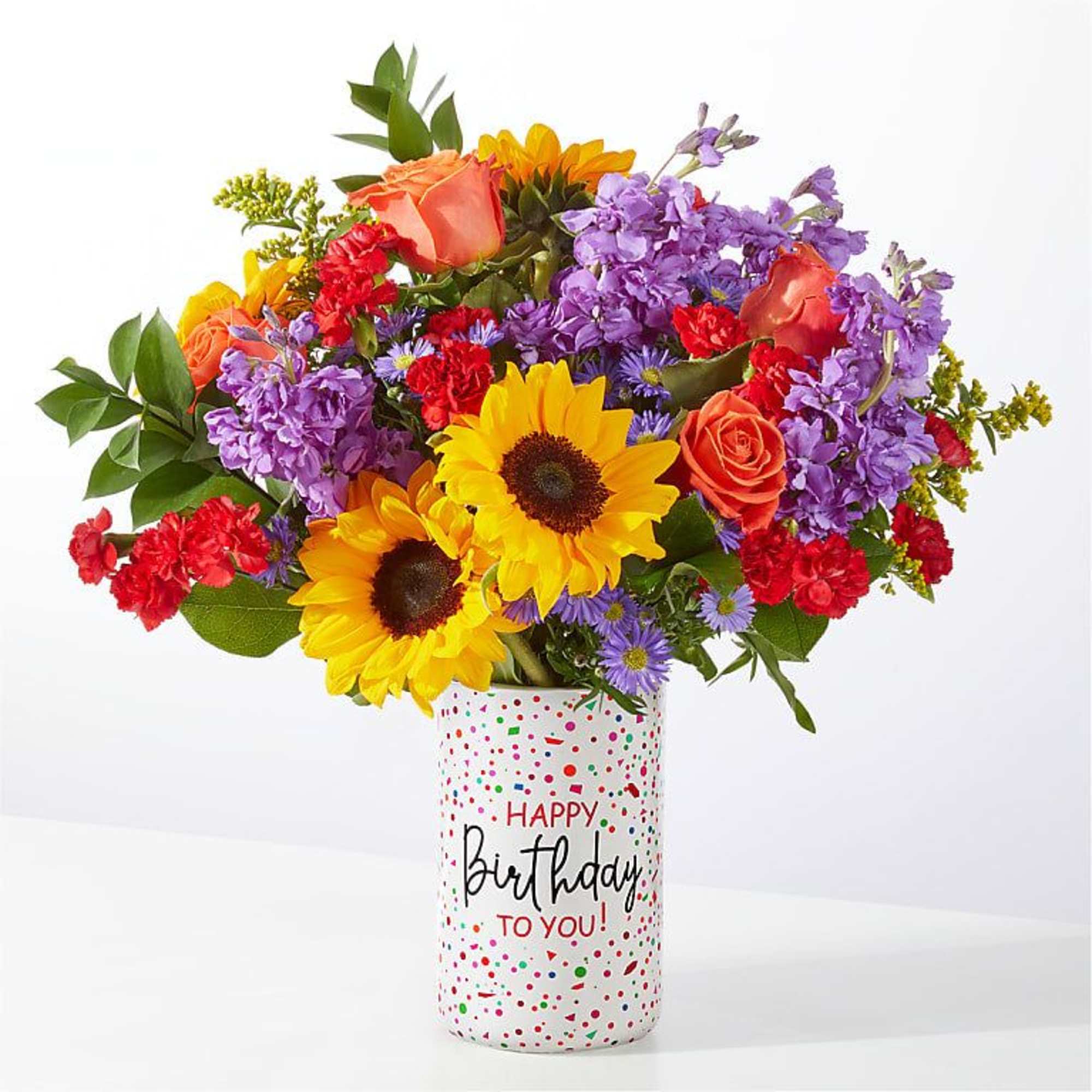 Mixed bouquet in a birthday vase with sunflowers, roses, and purple blooms