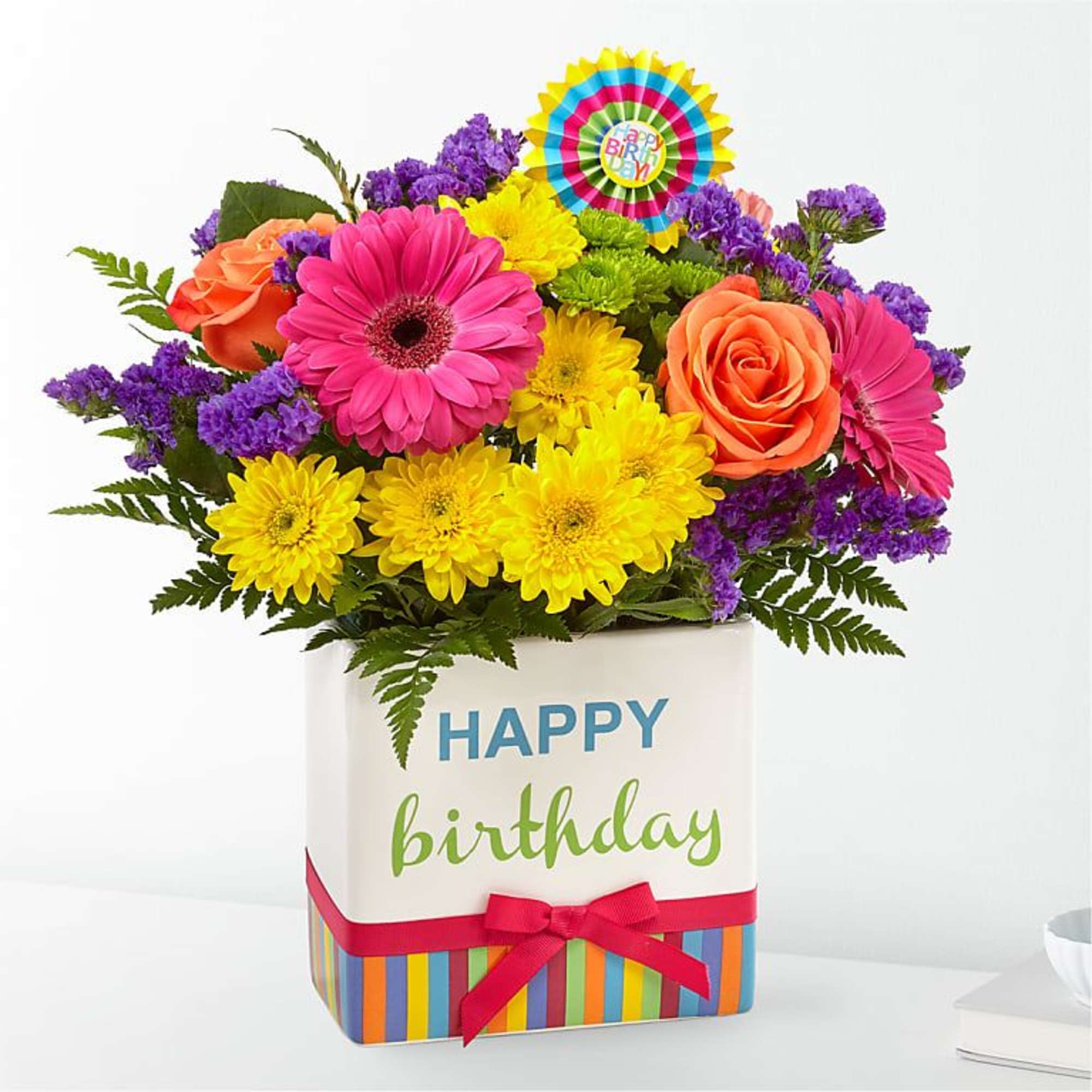 Bright mixed bouquet in a birthday gift box with a ribbon