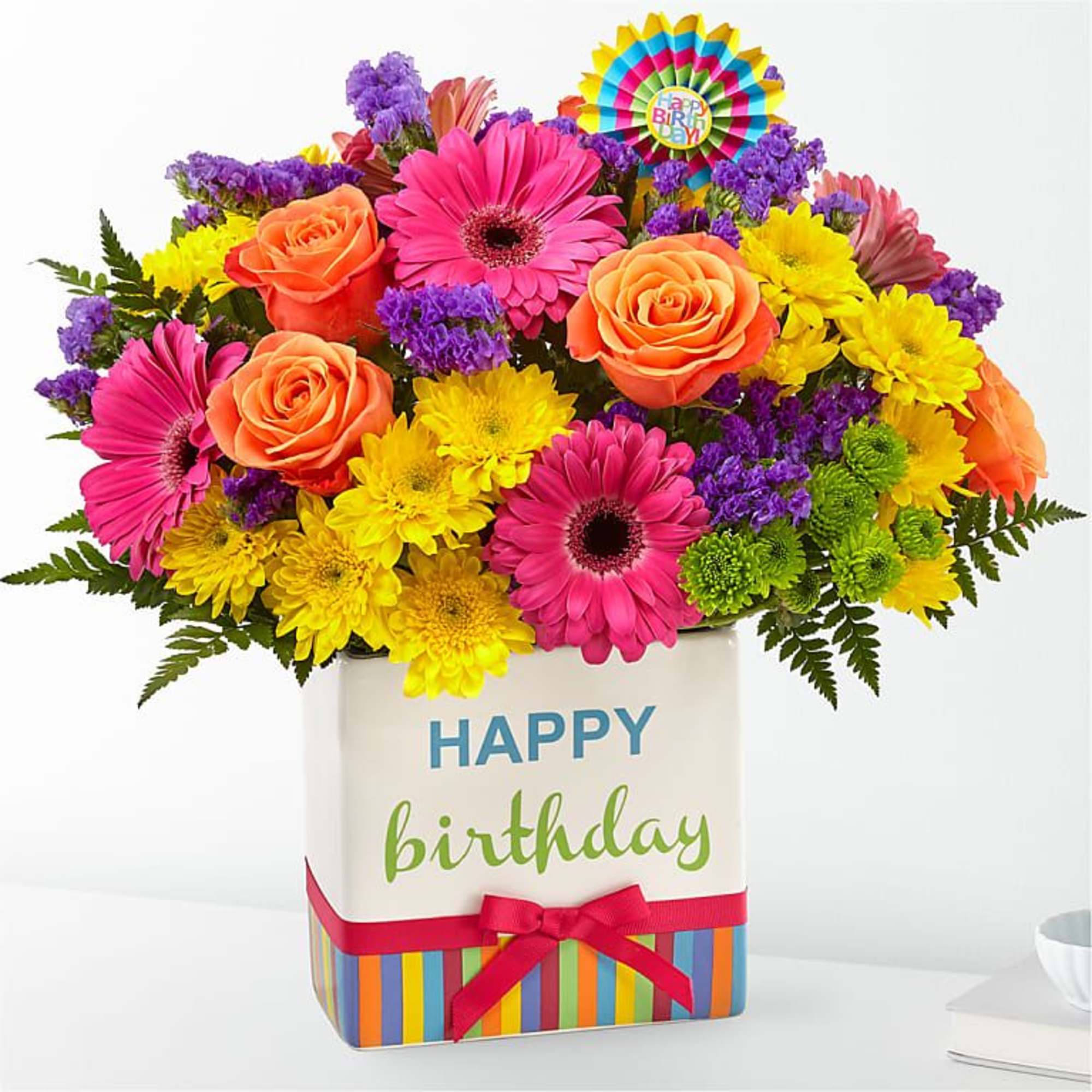 Bright mixed bouquet in a birthday gift box with a colorful topper