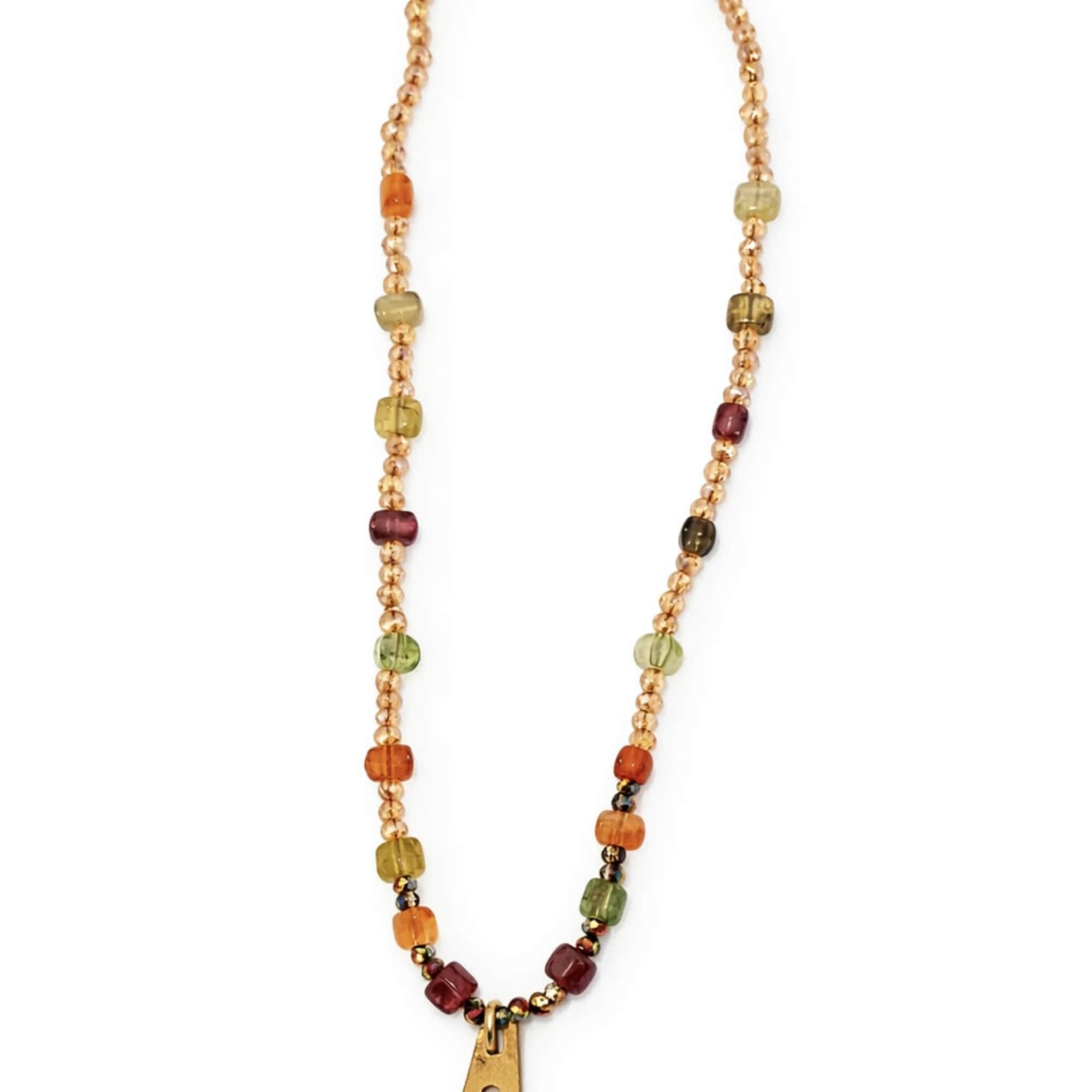 Beaded necklace with a gold pendant on a white background