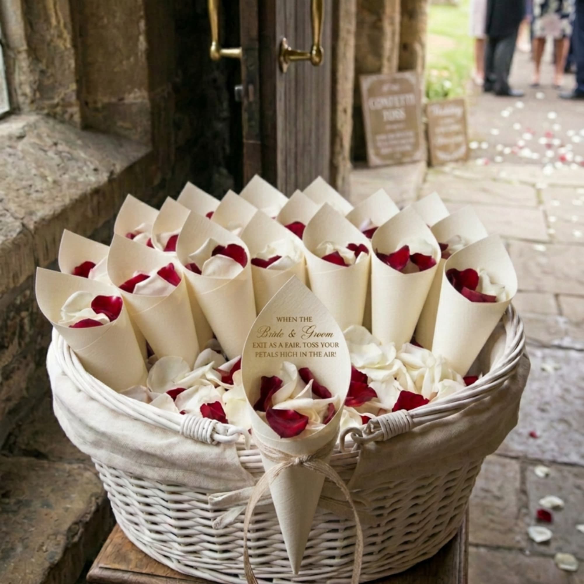 Basket of cream cones filled with red and white rose petals