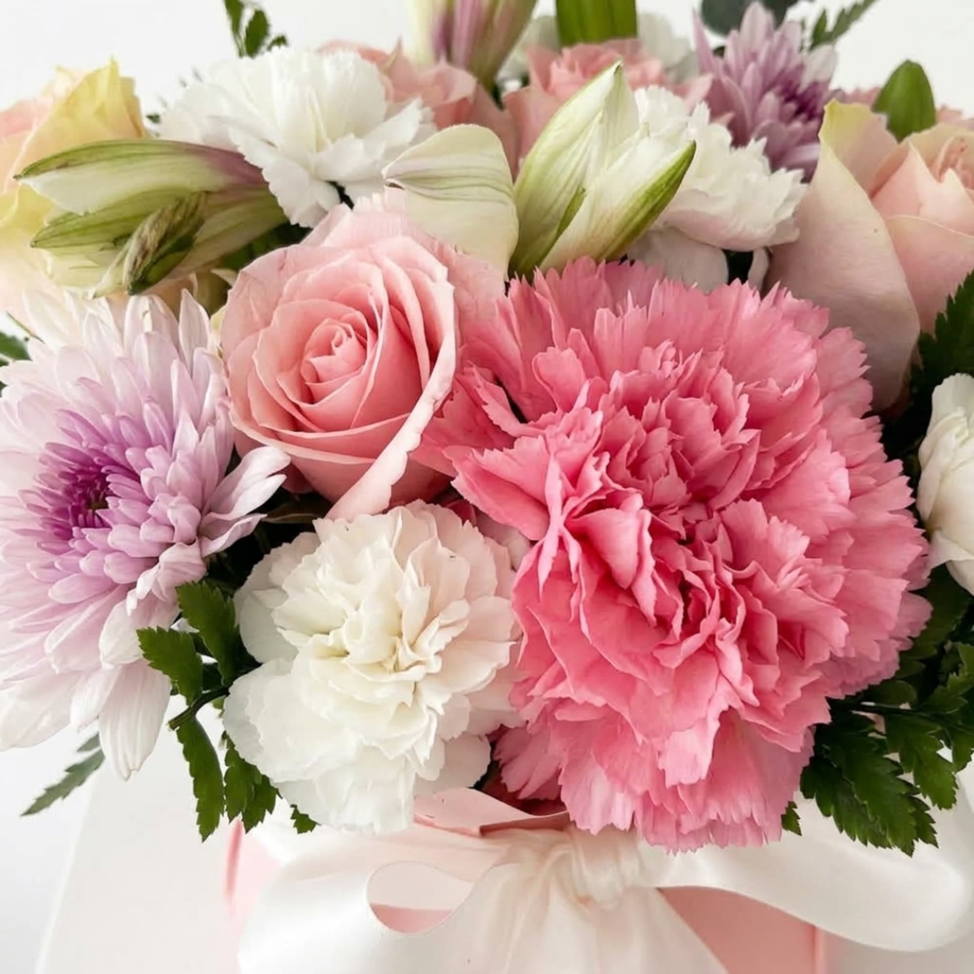 Pink and white mixed bouquet with roses, carnations, and chrysanthemums