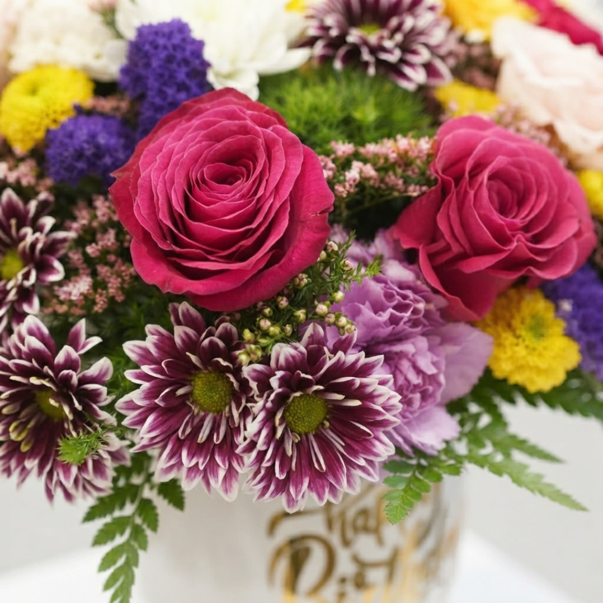Mixed bouquet with pink roses and purple chrysanthemums in a vase