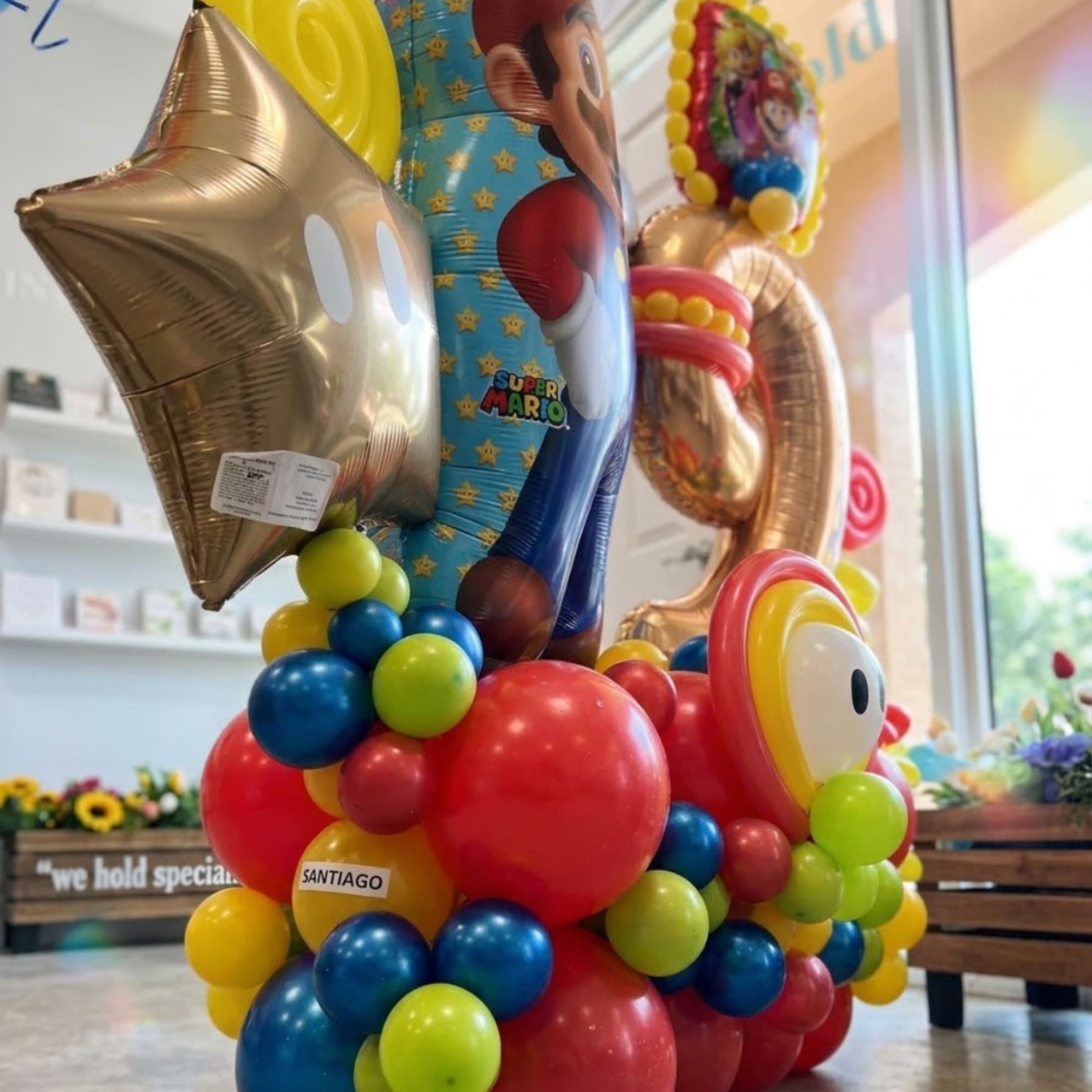 Colorful balloon display with a gold star and Super Mario balloons