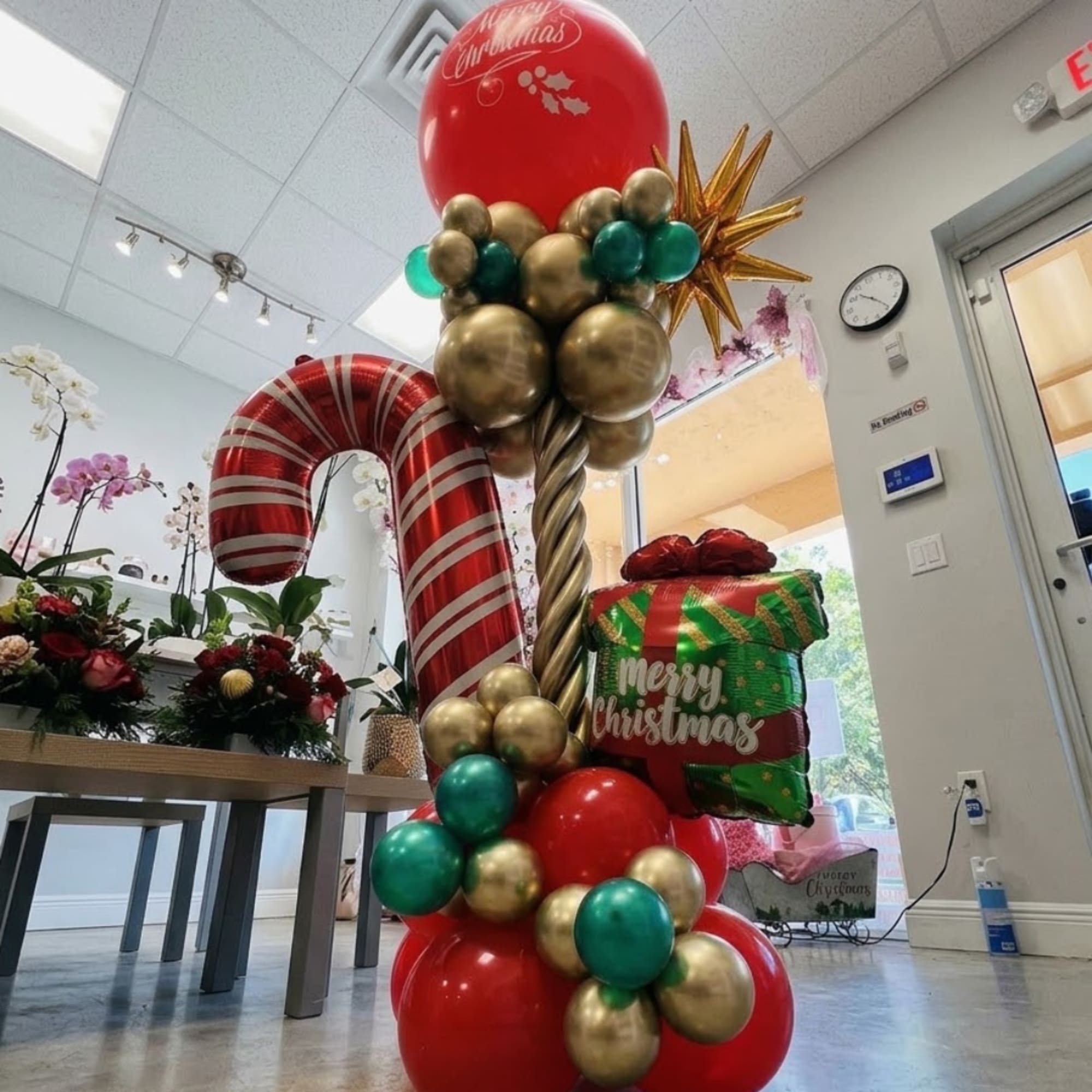 Christmas balloon display shaped like a candy cane and gift box