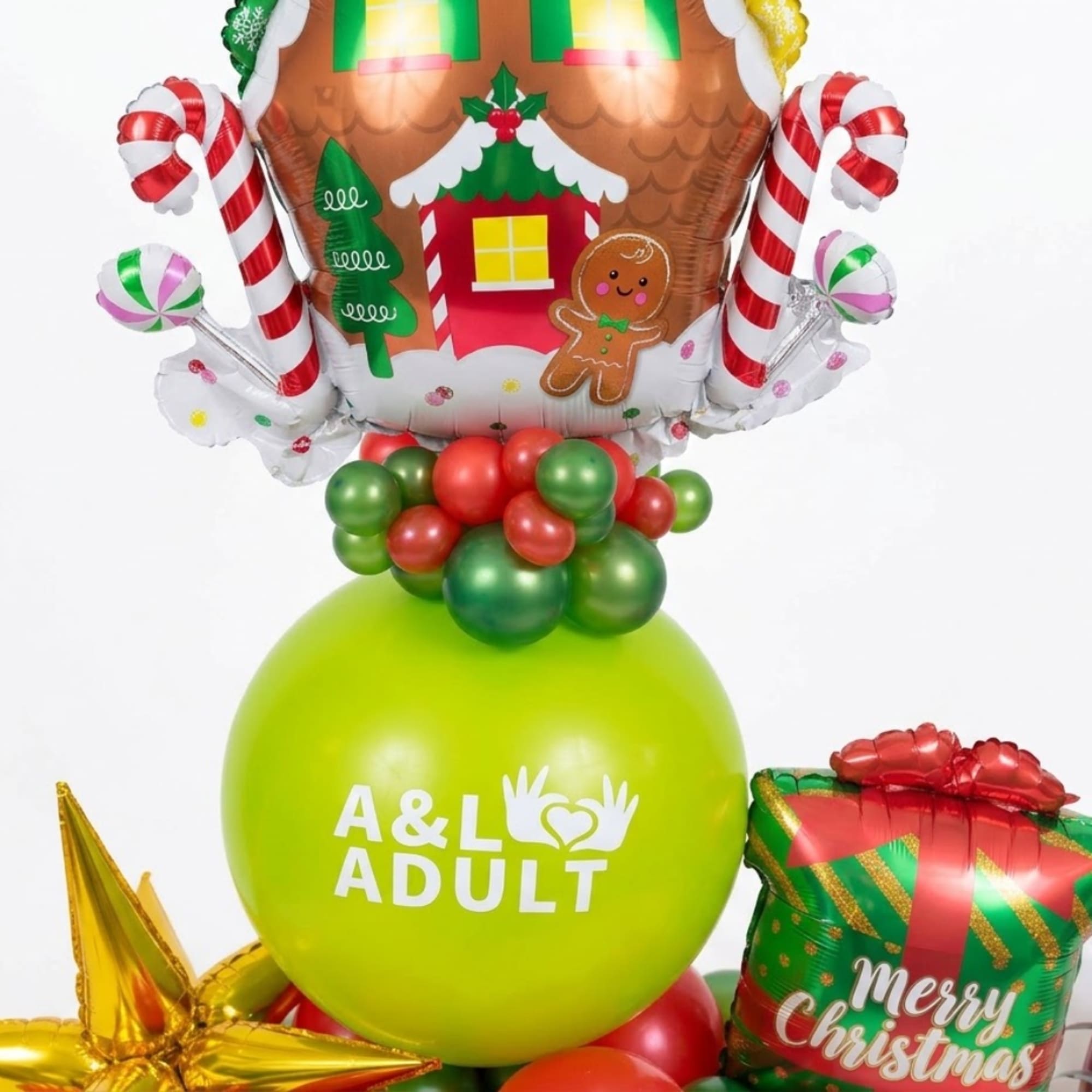 Christmas balloon arrangement with a gingerbread house balloon and gift balloons