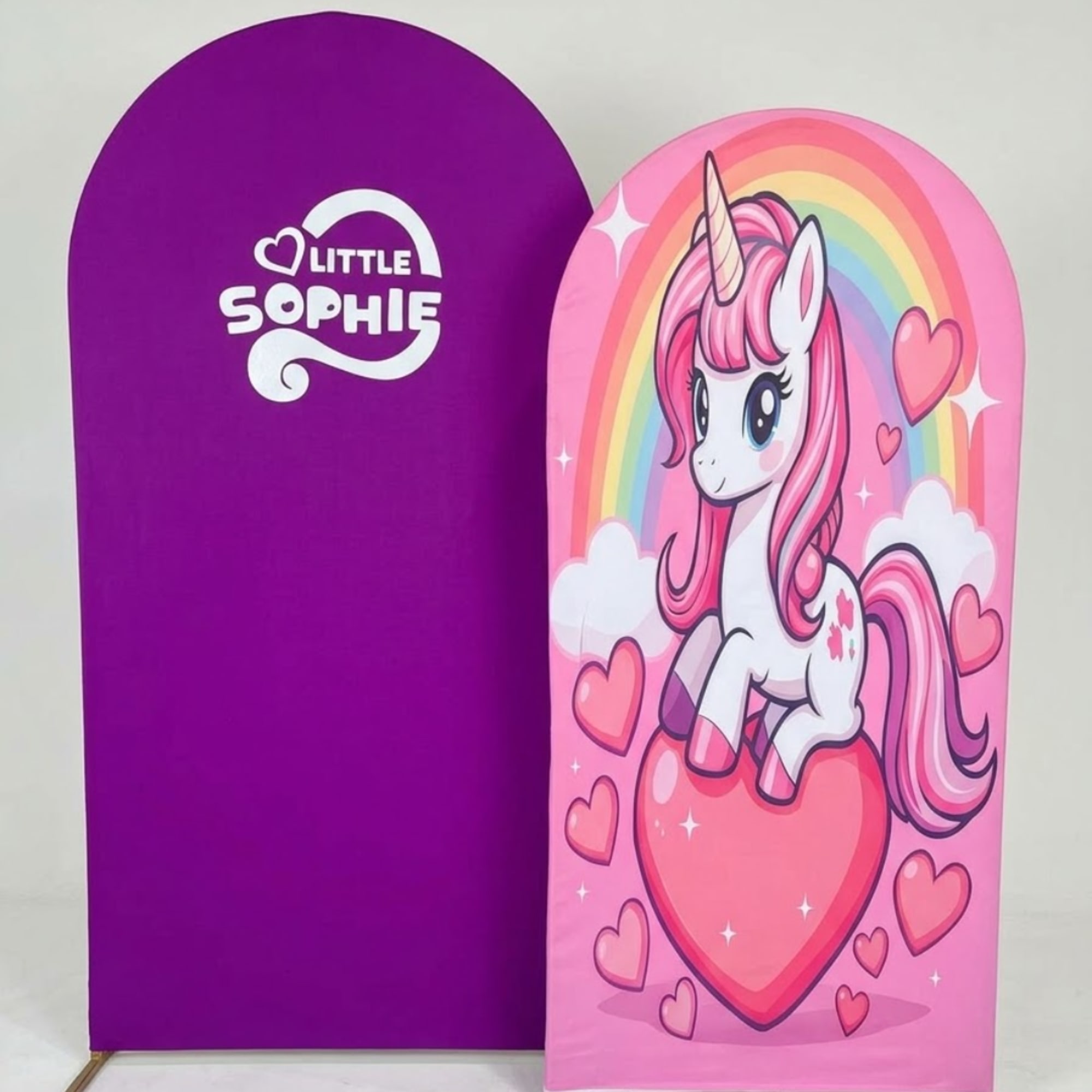 Purple and pink unicorn-themed display boards with a rainbow and hearts