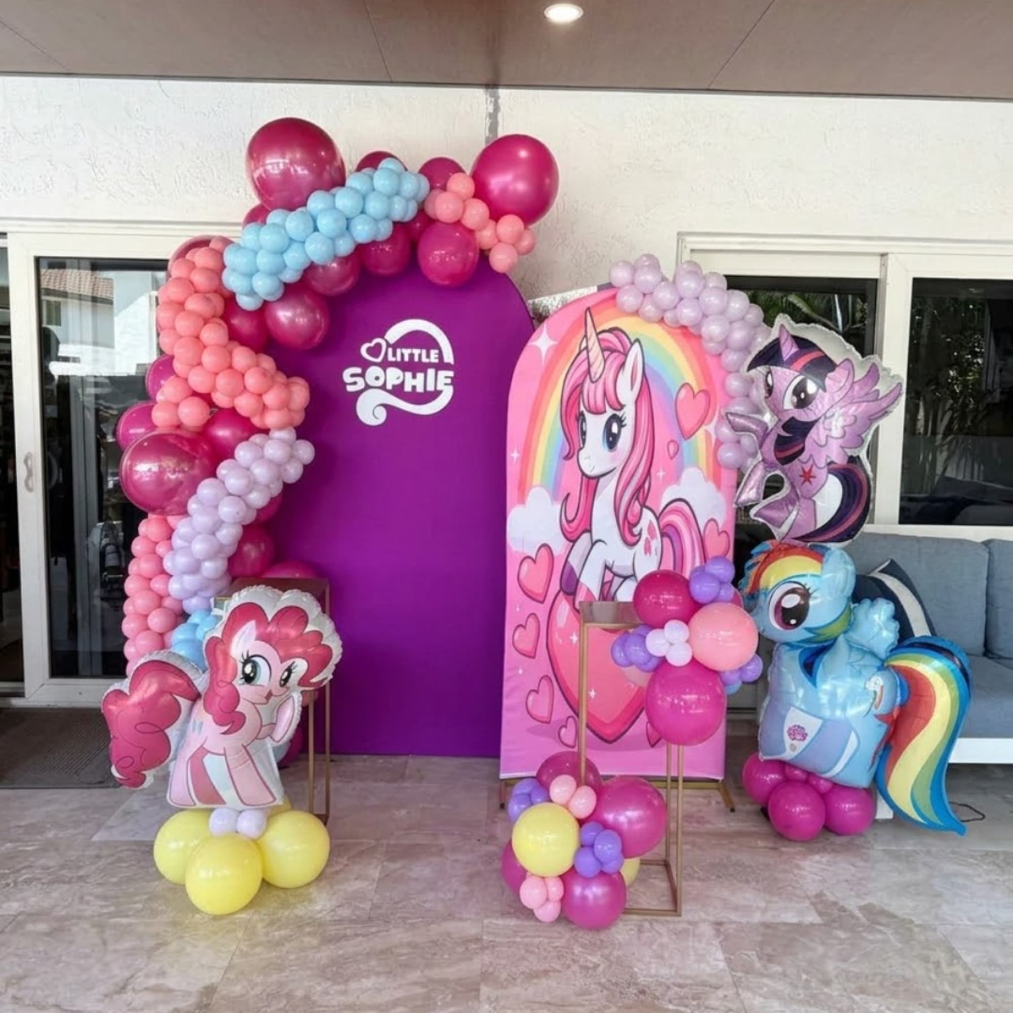 My Little Pony-themed balloon display with character cutouts and colorful arches