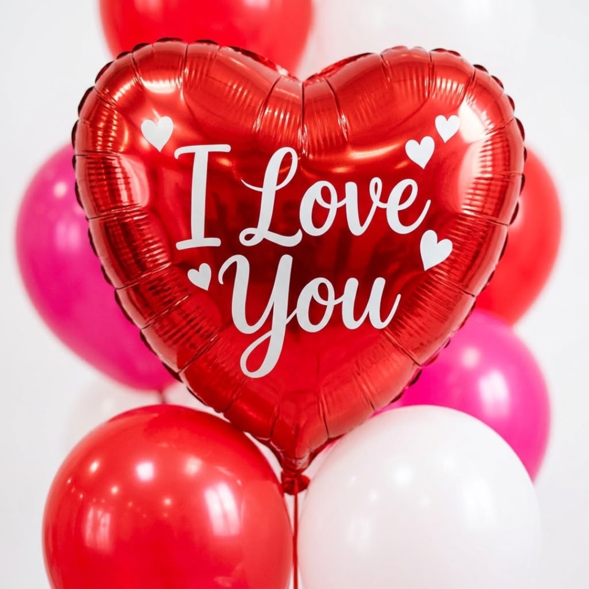 Heart-shaped red balloon with "I Love You" text, surrounded by round balloons