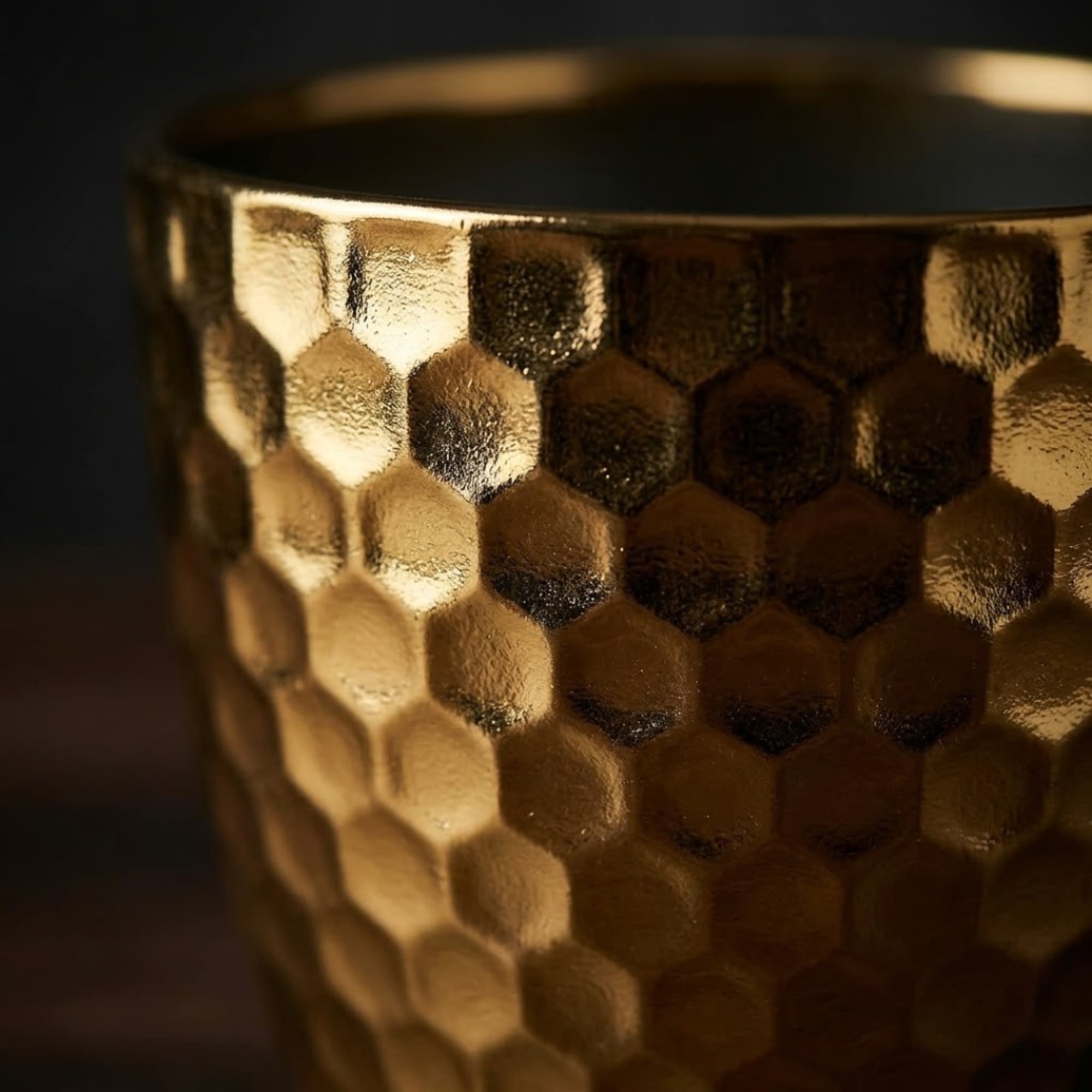 Gold textured candle holder with a hexagonal pattern