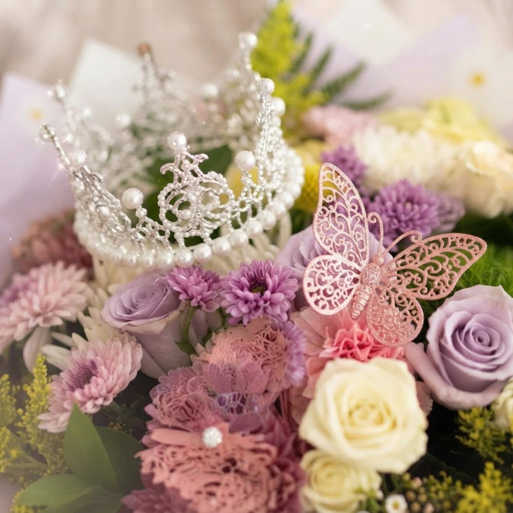 Pastel bouquet with roses, daisies, and a pearl tiara topper