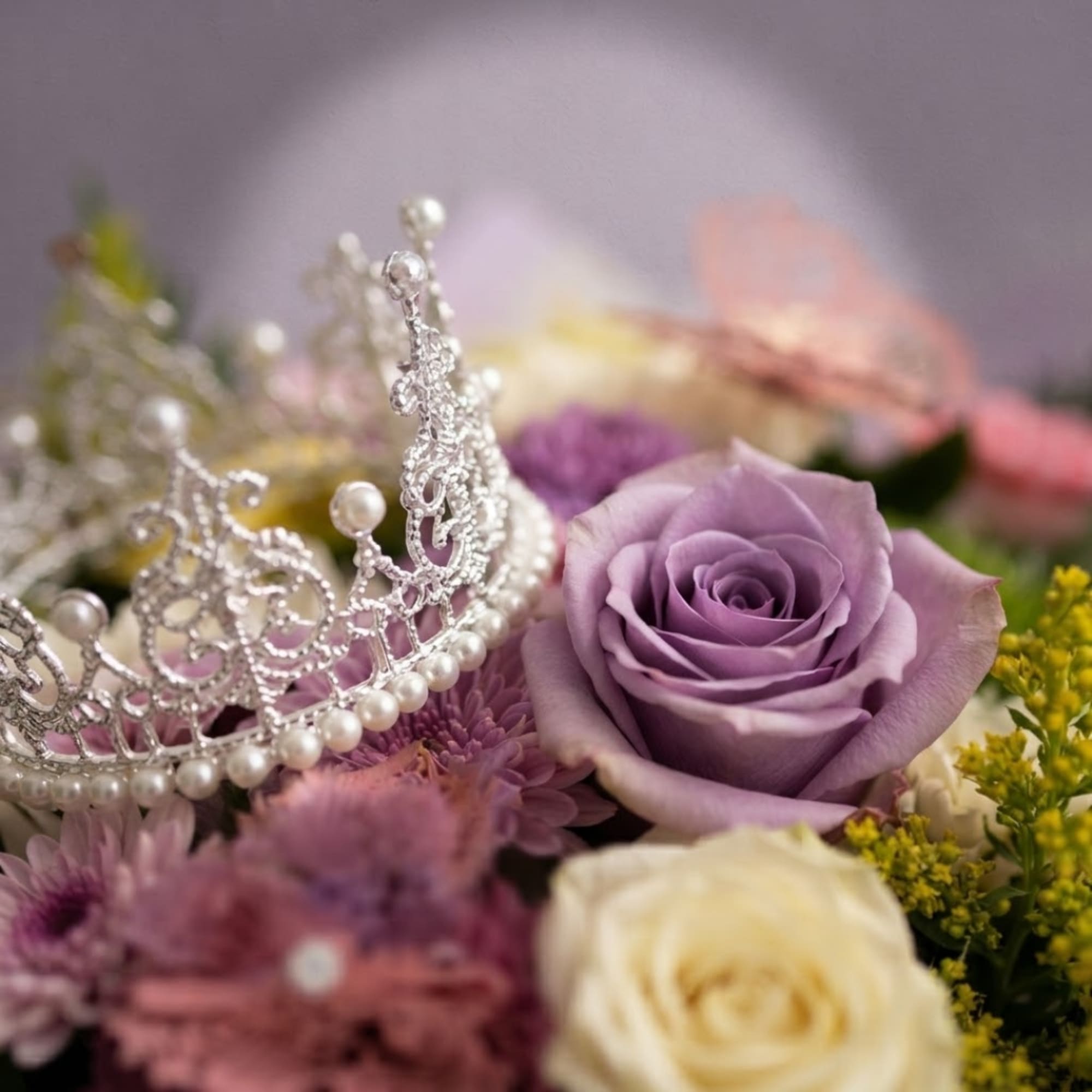 Lavender rose bouquet with a silver tiara and pearl accents