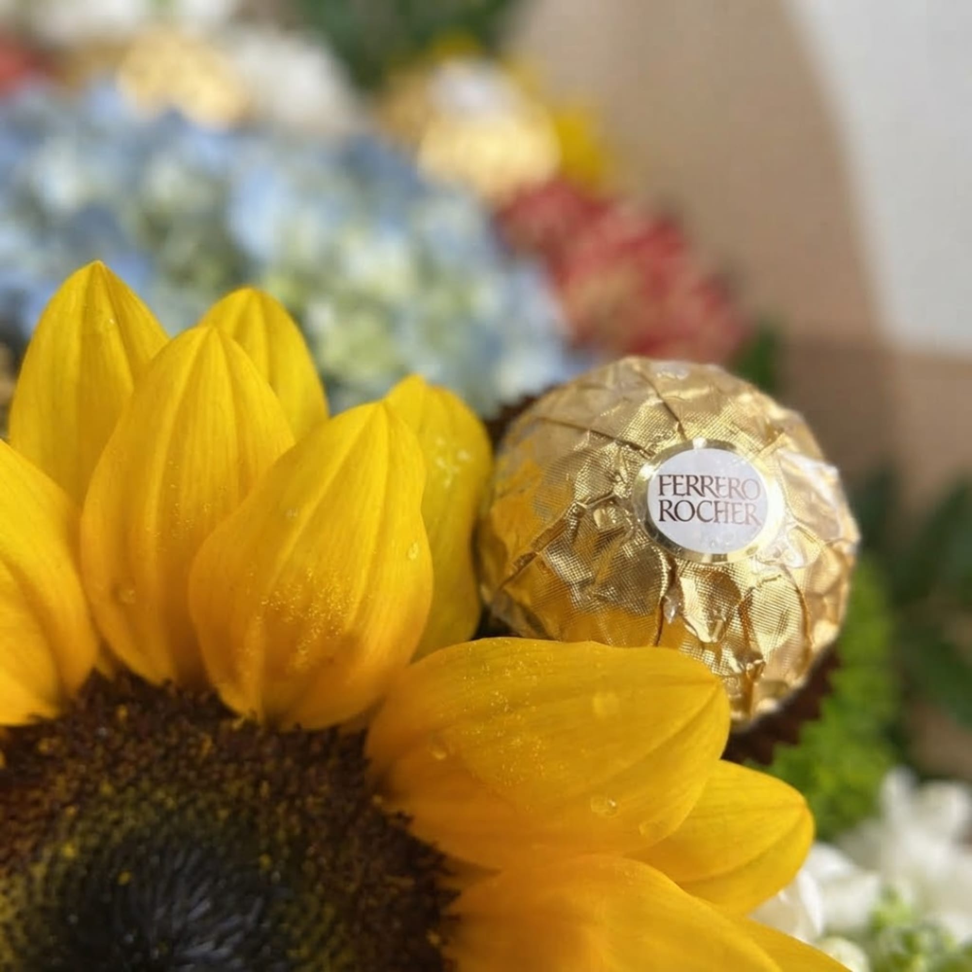 Sunflower arrangement with a Ferrero Rocher chocolate in the center