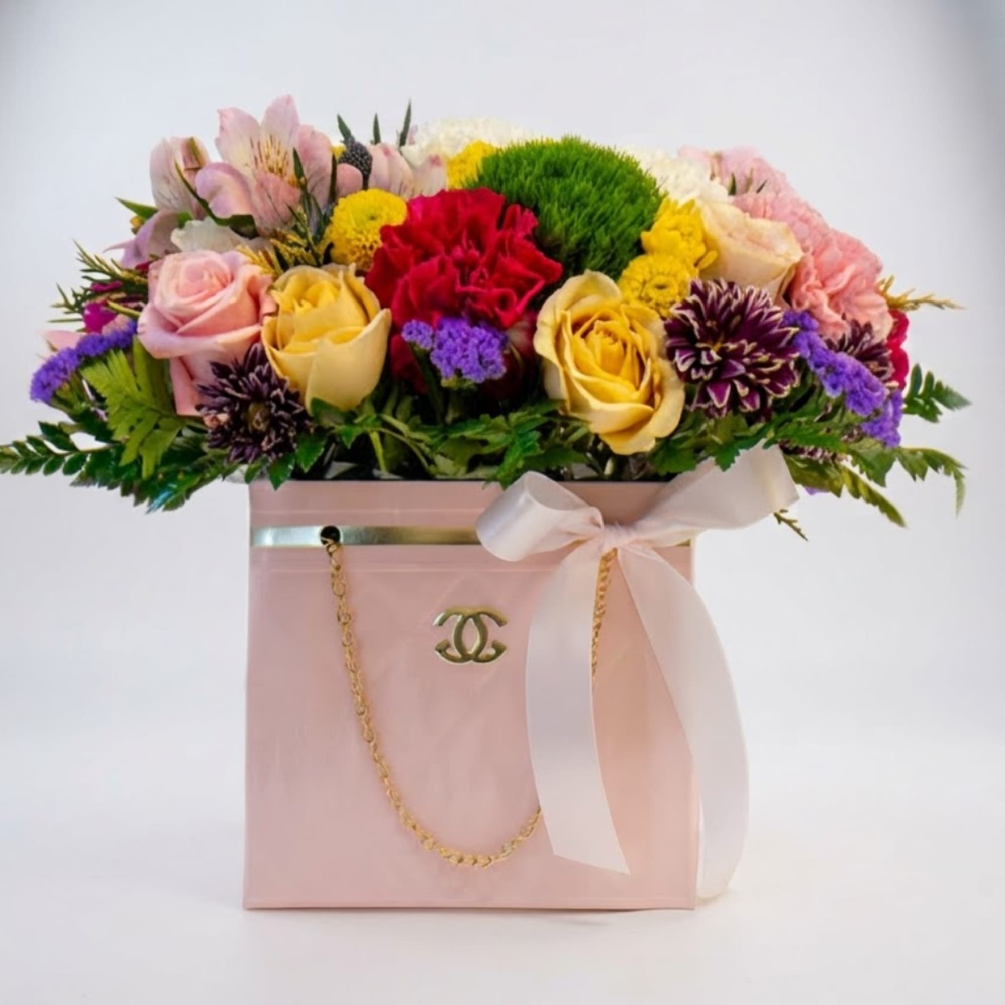 Mixed bouquet in a pink gift box with a white ribbon