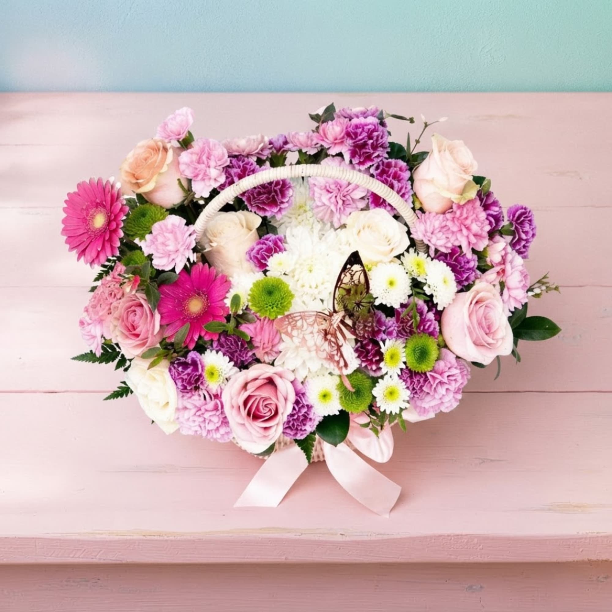 Heart-shaped flower basket with pink, purple, and white blooms