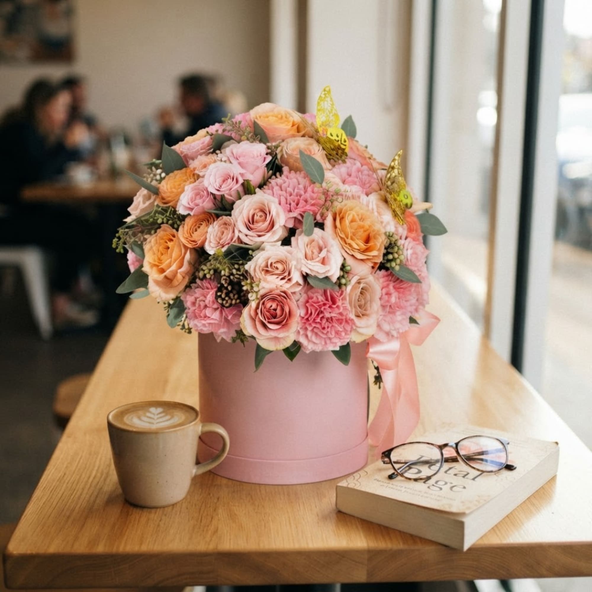 Pink and peach rose bouquet in a pink box on a table