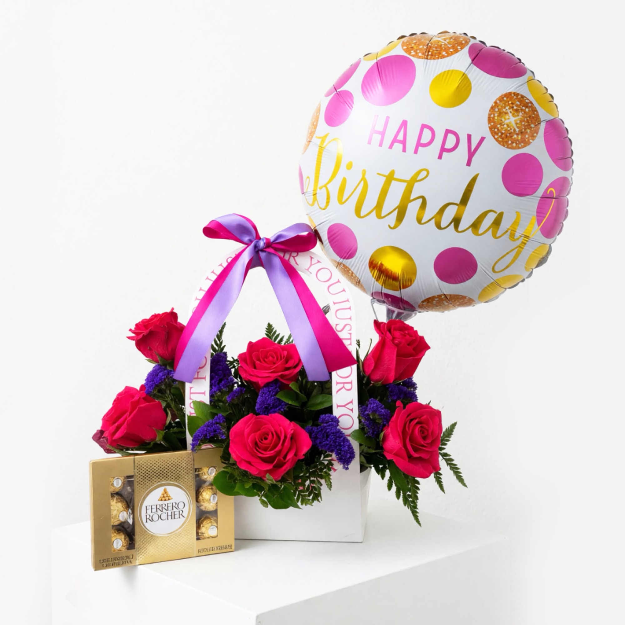 Pink rose arrangement with a birthday balloon and chocolate box