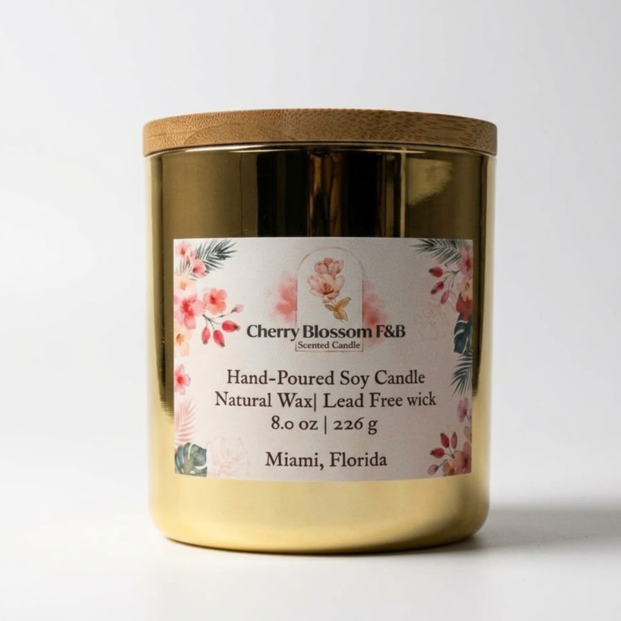 Gold candle jar with a floral label and wooden lid