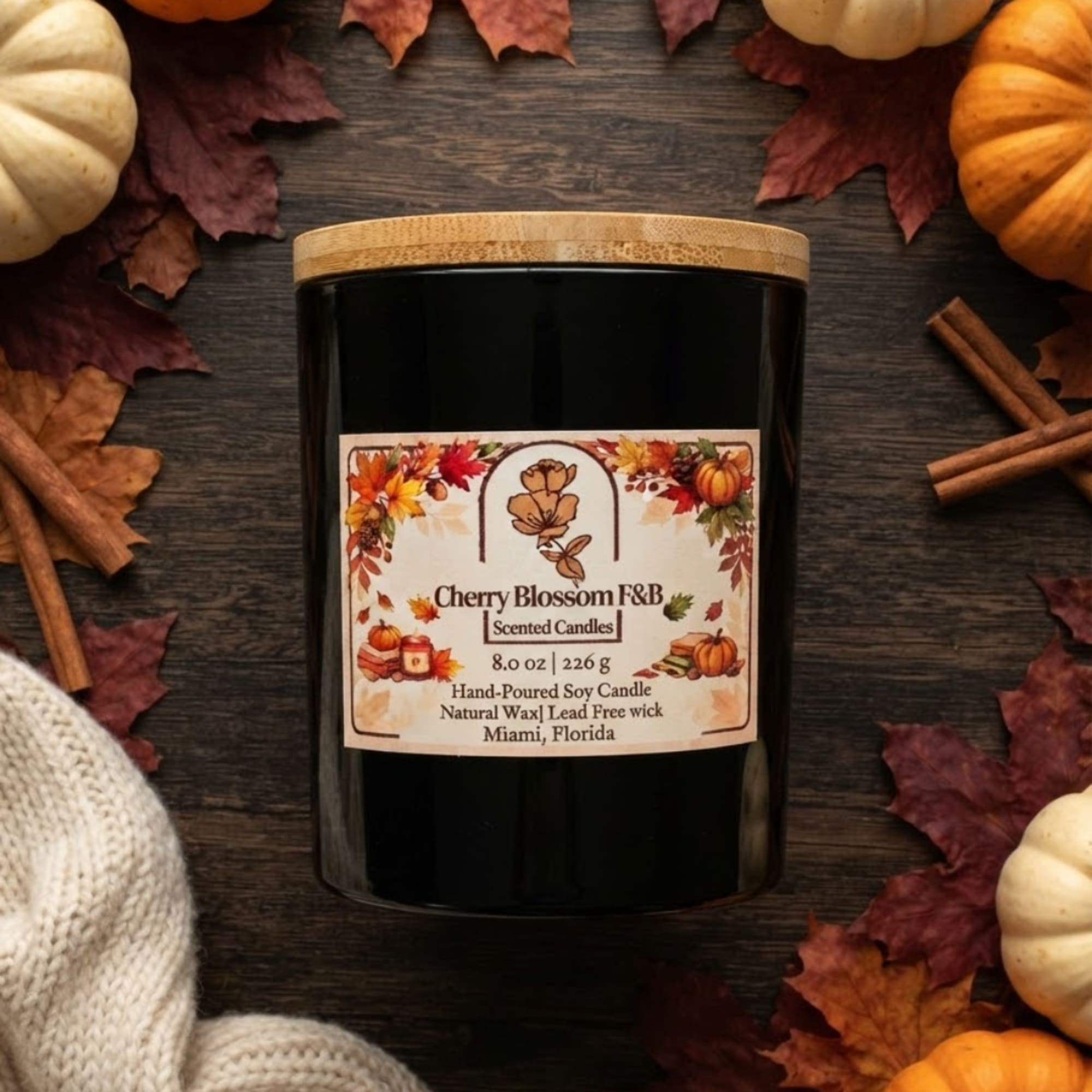 Black candle jar with a fall-themed label and wooden lid