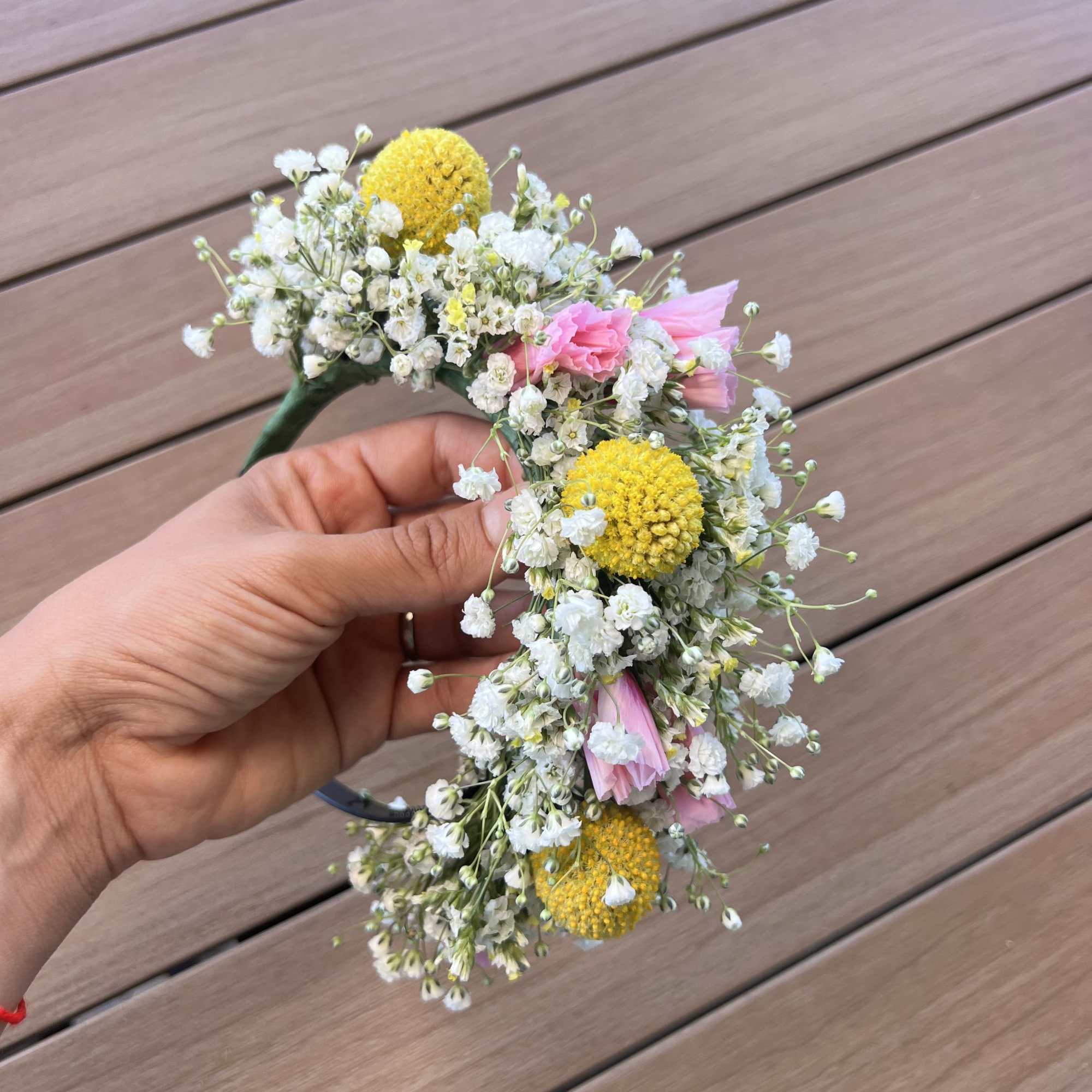 Floral crown with white baby's breath, yellow blooms, and pink flowers