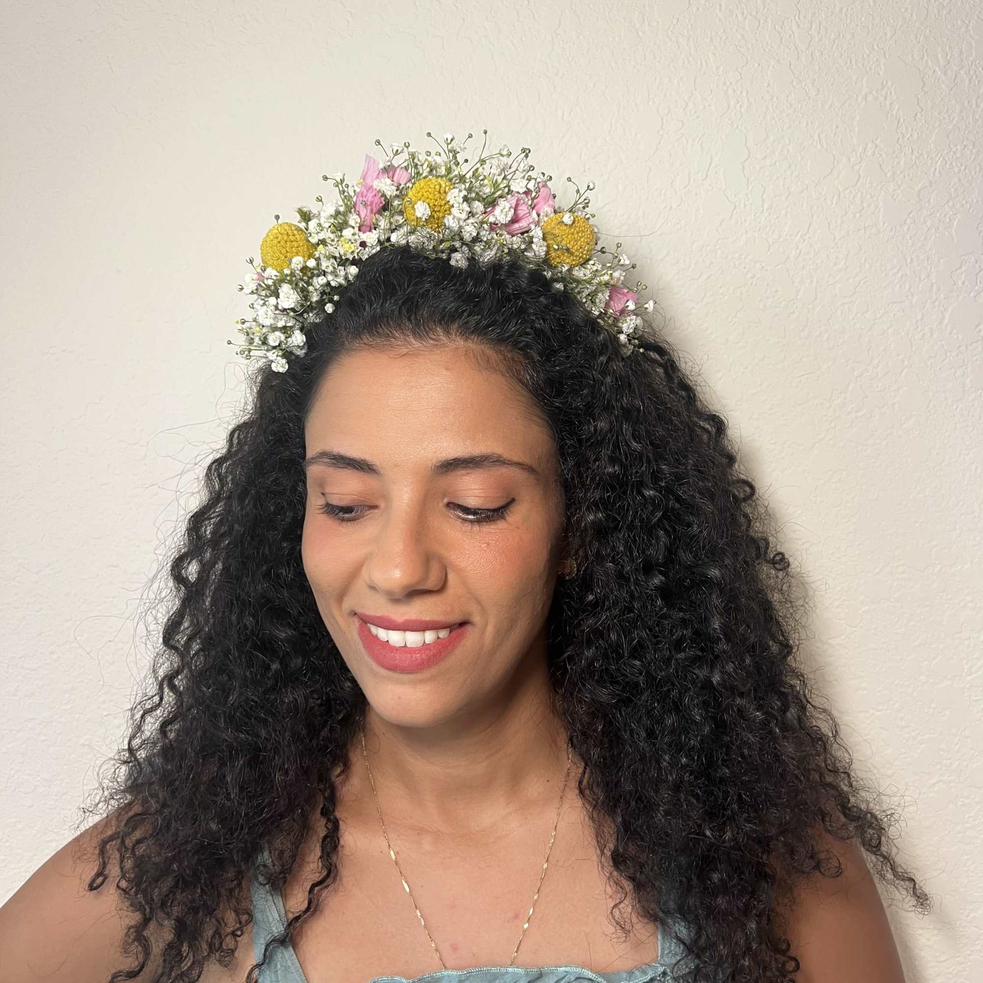Woman wearing a floral crown with pink and yellow flowers