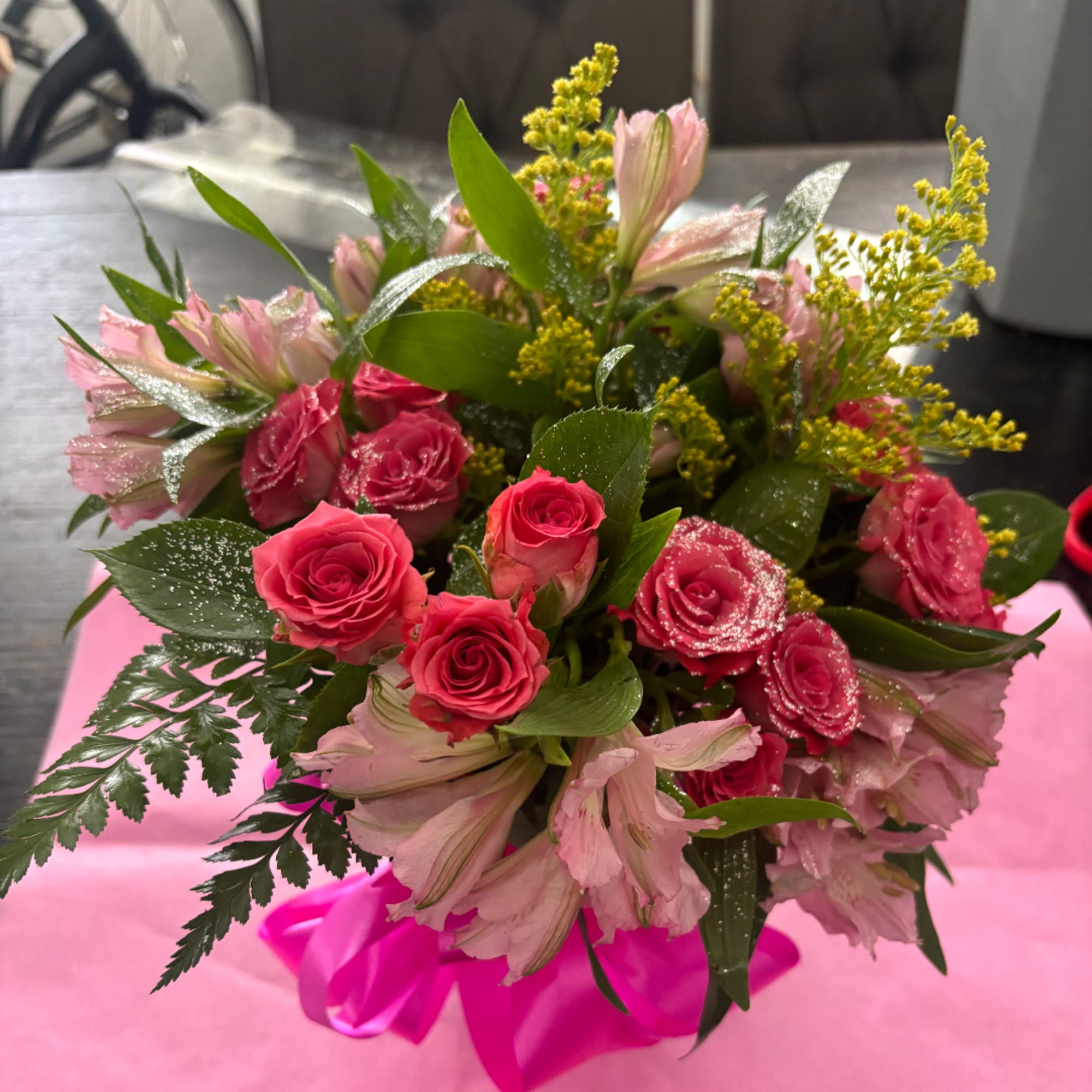 Pink roses and pale pink alstroemeria bouquet with yellow filler flowers