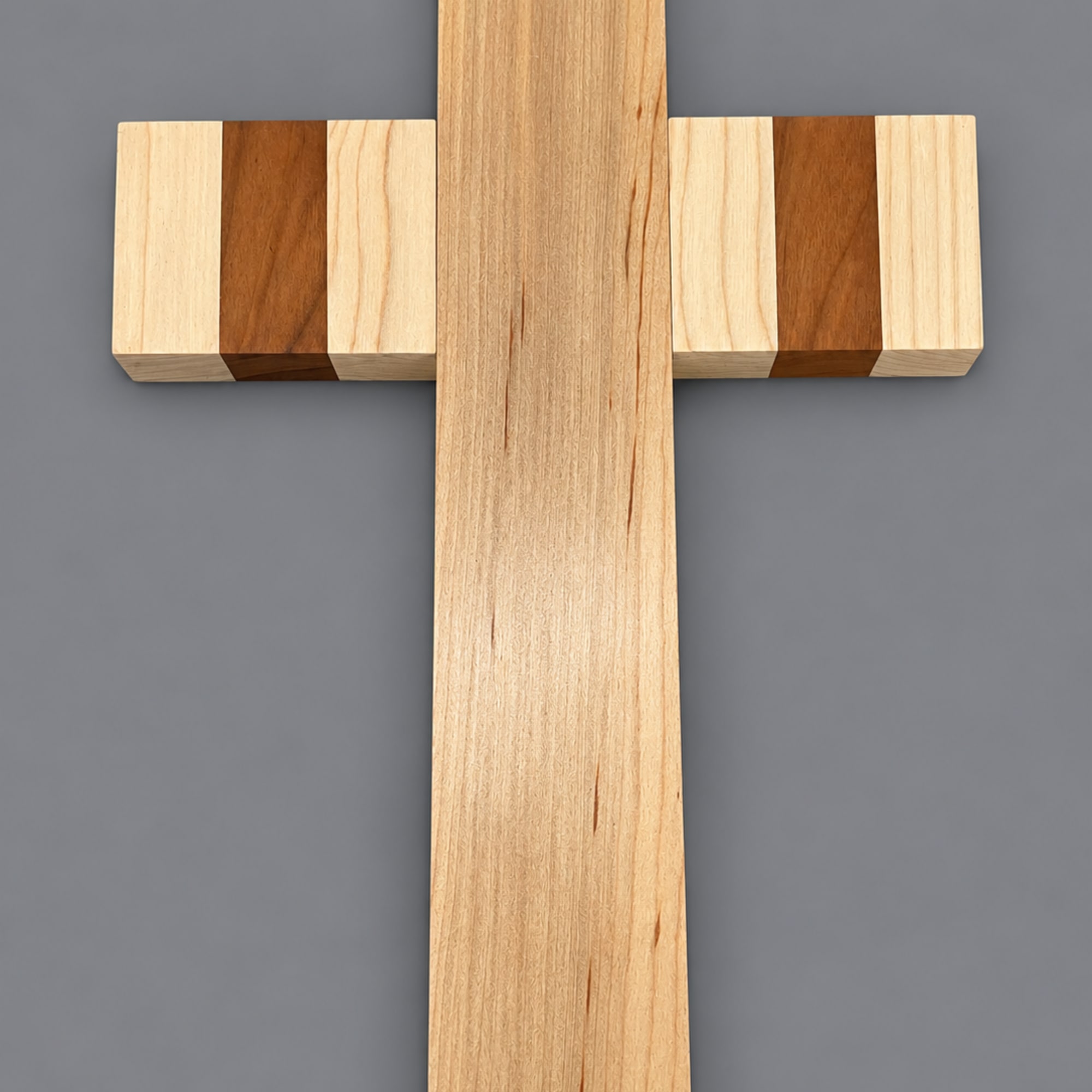 Wooden cross-shaped wall decor on a gray background